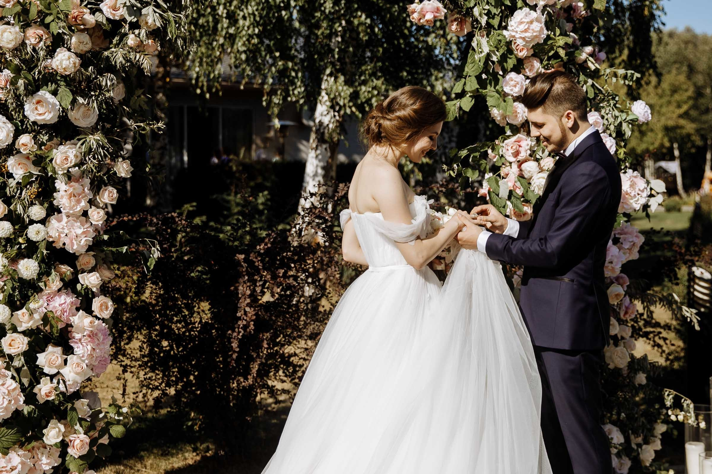 Couple exchanging vows in garden venue, by Tanya Bogdan, Truro editorial wedding photographer.  