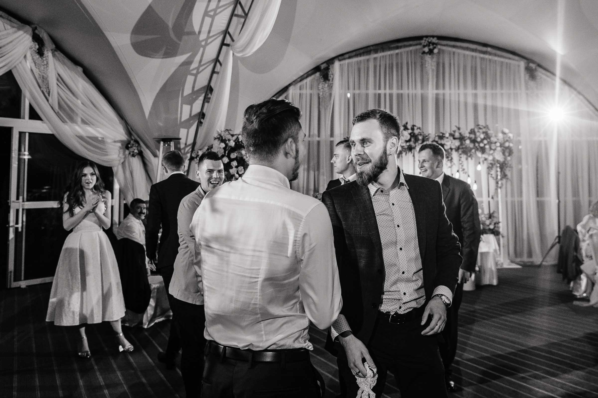 Guests dancing under marquee, by Tanya Bogdan, Truro wedding photography.  