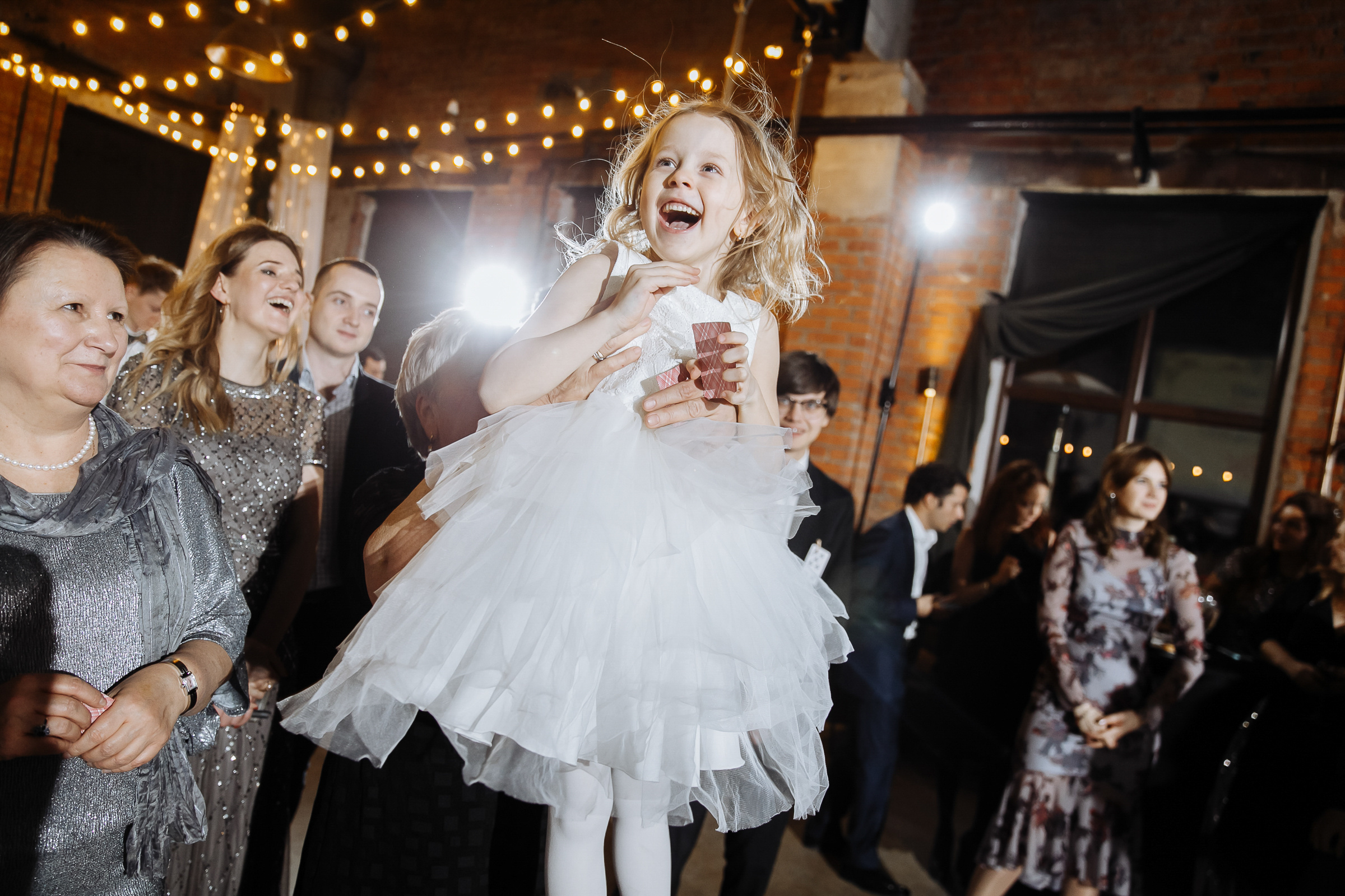 Child dancing in indoor light, by Tanya Bogdan, Plymouth wedding photography.  