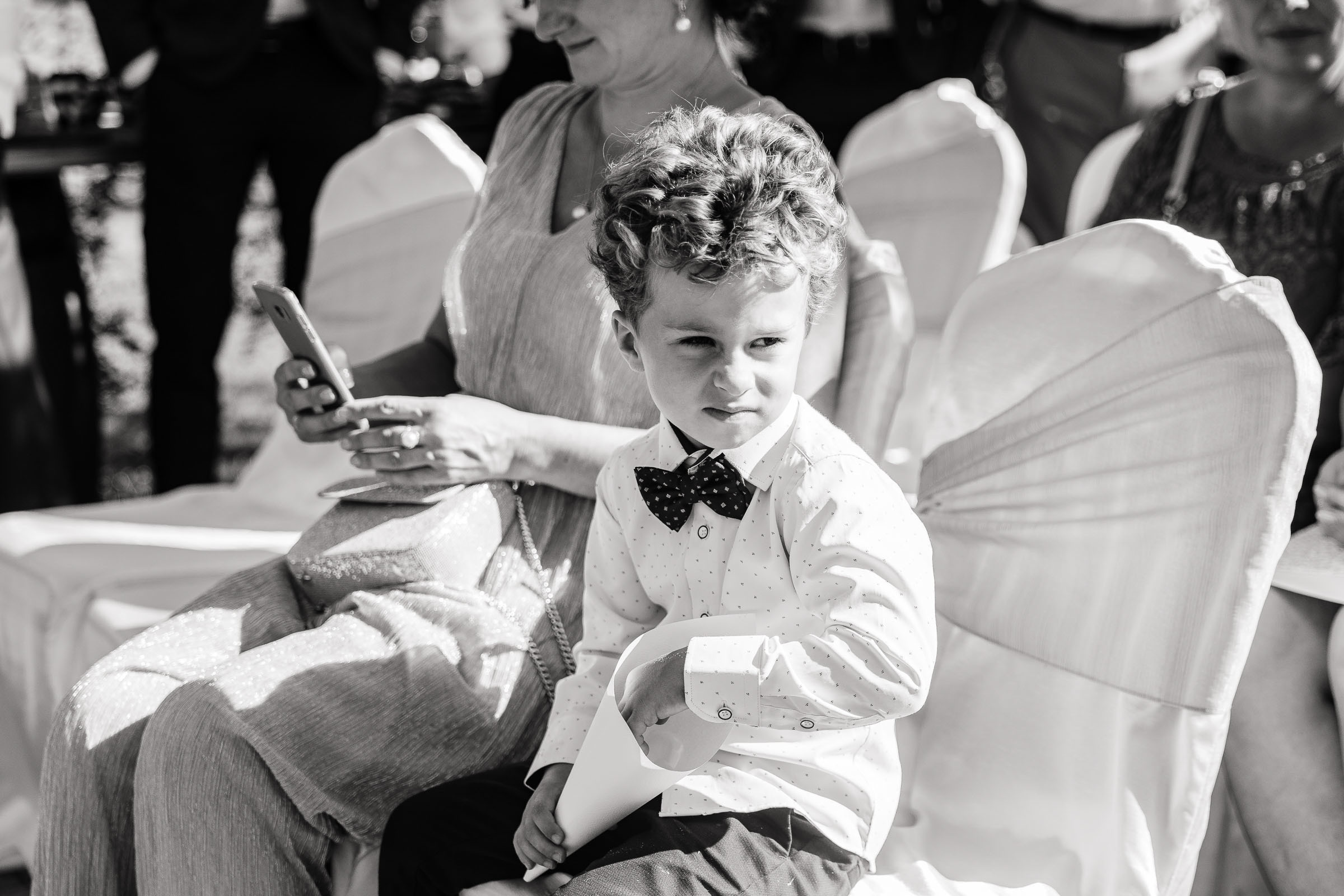 Page boy sitting by Tanya Bogdan, London wedding photographer.  