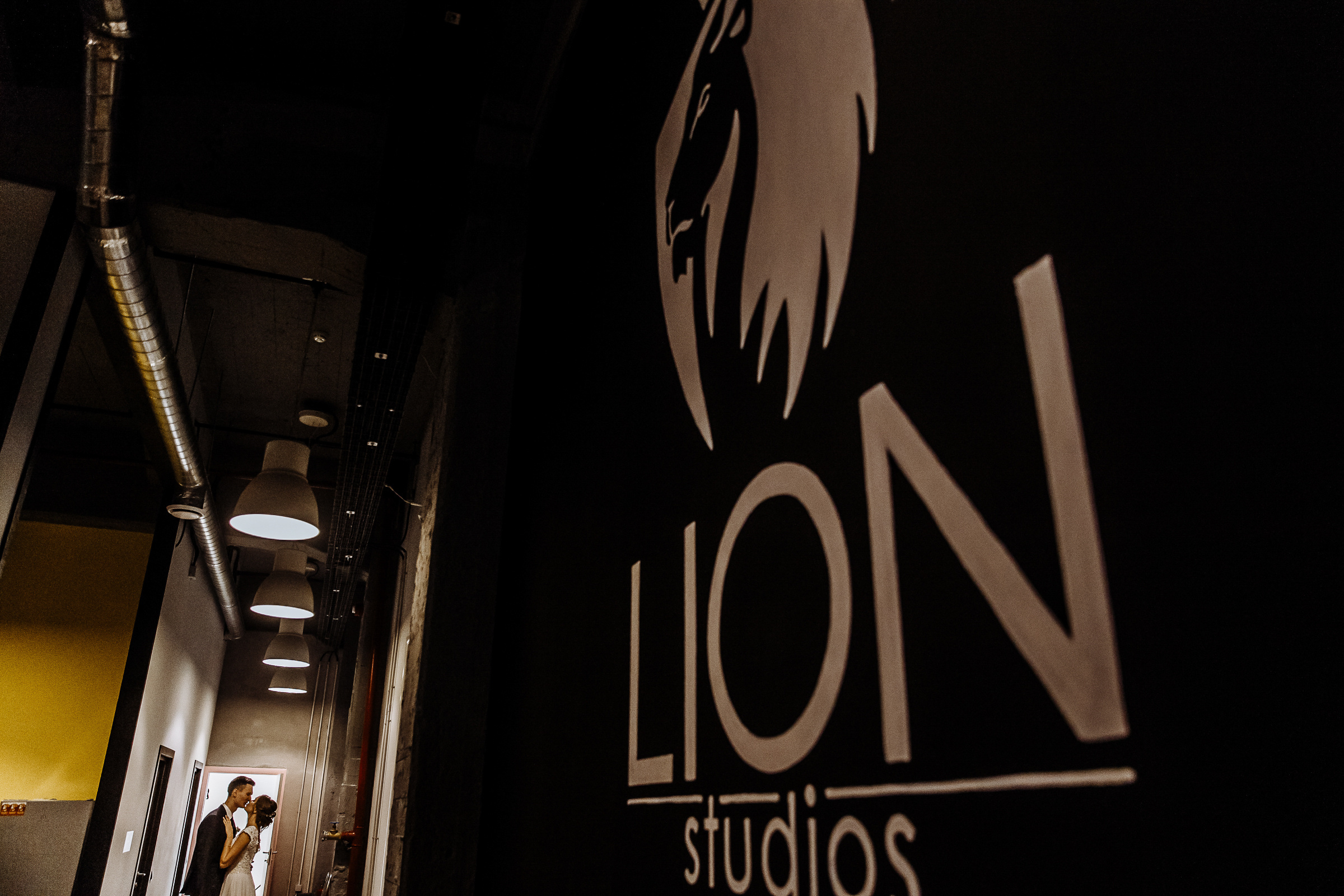 Bride and groom portrait in studio entrance kiss, by Tanya Bogdan, Bude, Cornwall wedding photography.  