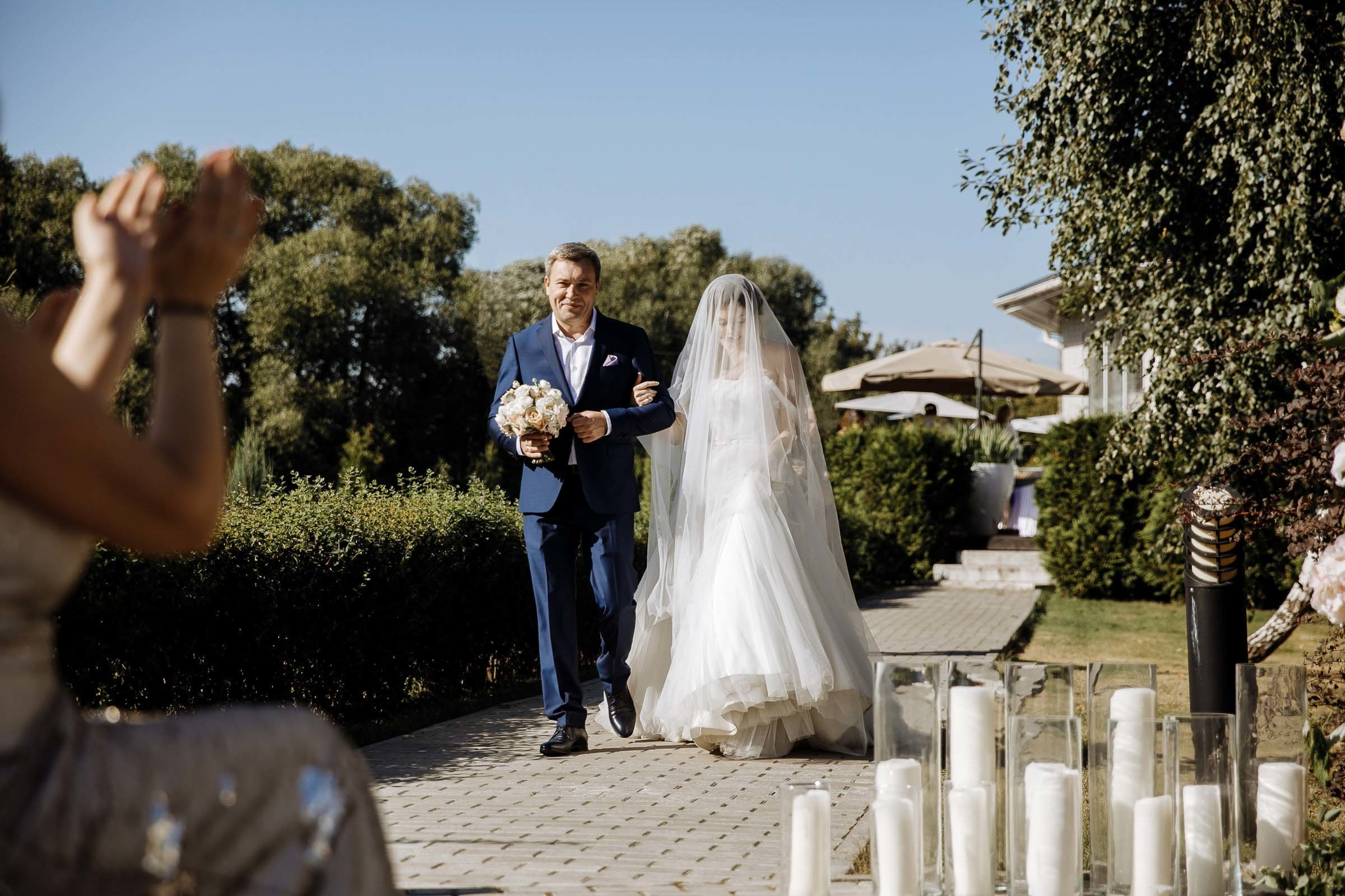 Bride walking down aisle with father, by Tanya Bogdan, Bude, Cornwall wedding photographer.  
