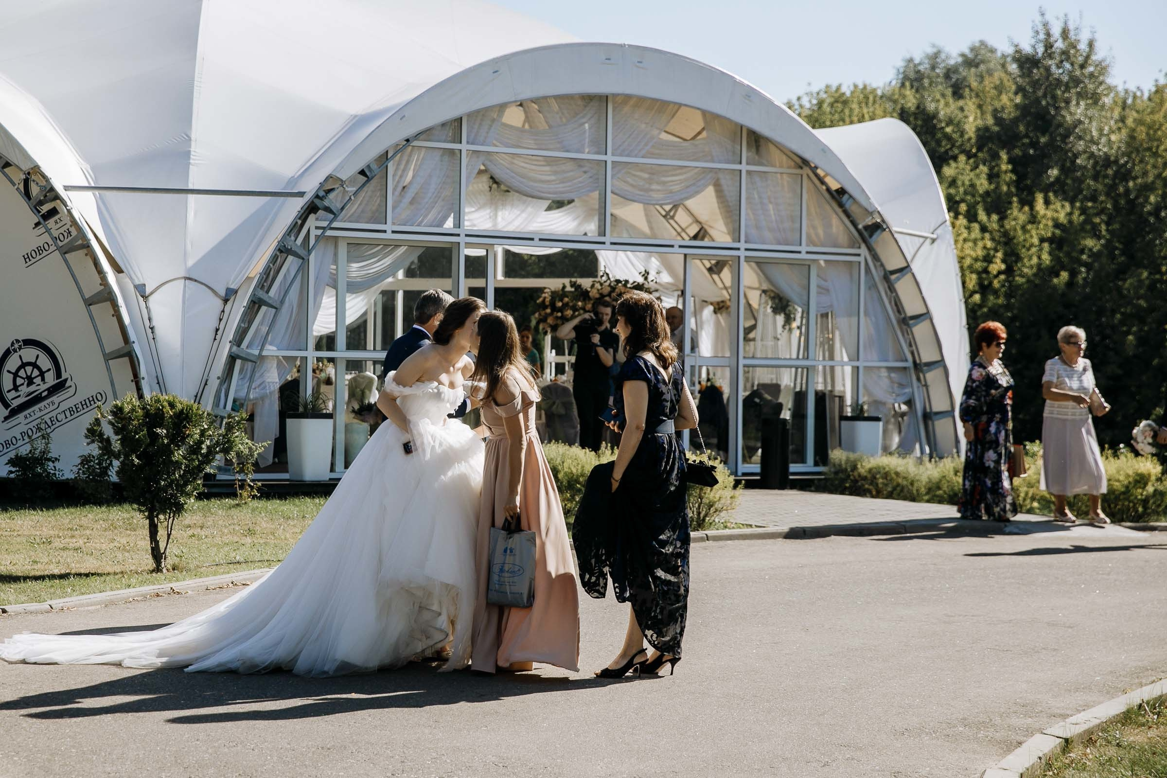 Bride walking down aisle in garden, by Tanya Bogdan, Bude, Cornwall wedding photographer.  