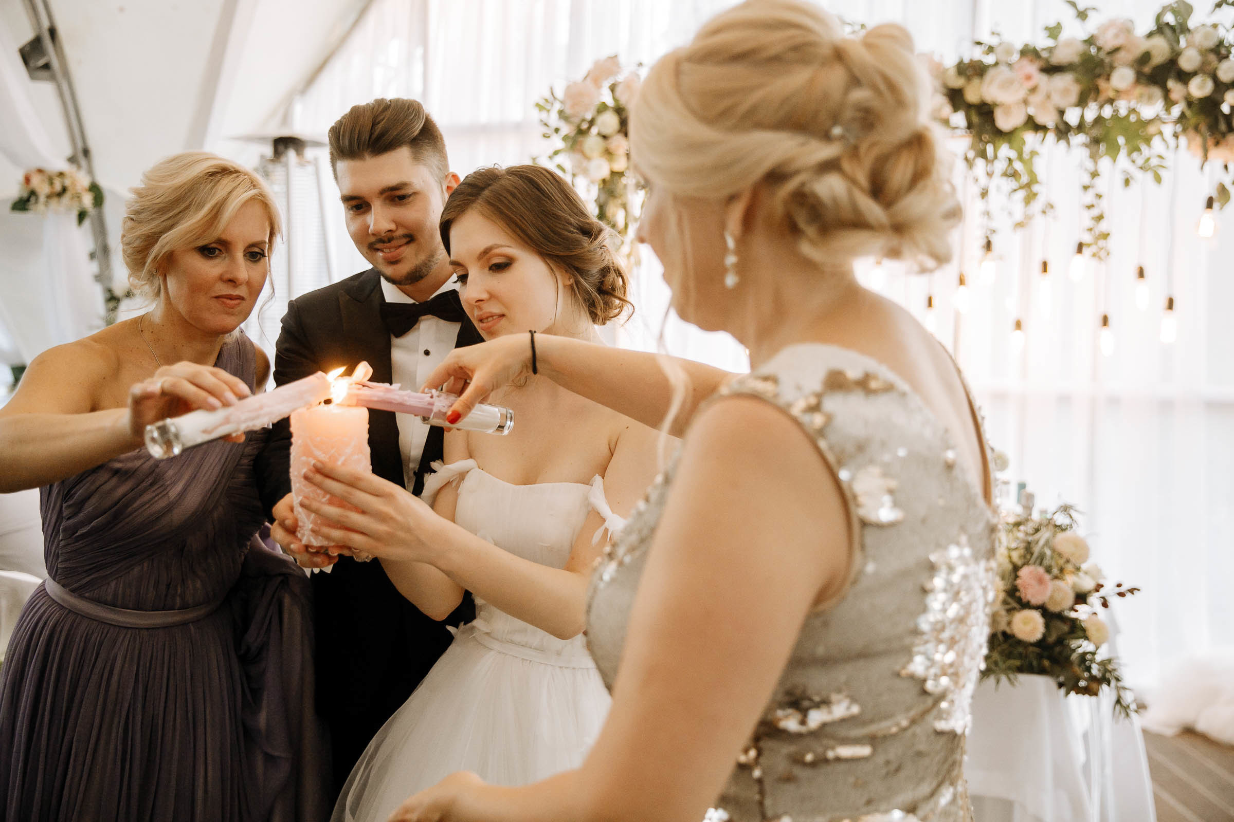 Couple lighting candle in venue, by Tanya Bogdan, Bude wedding photography.  