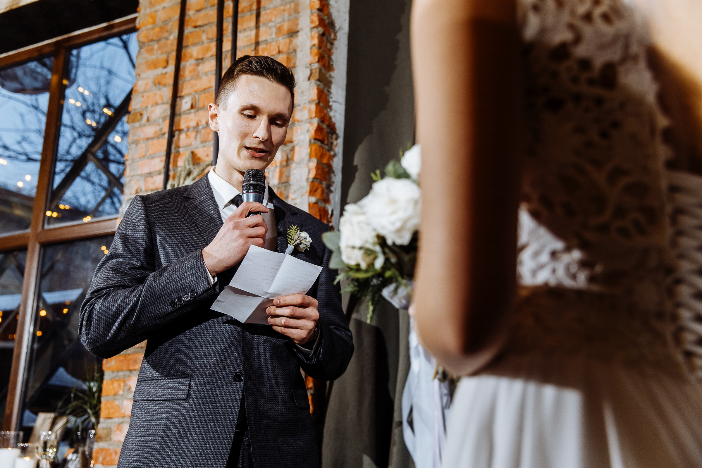 Groom's emotional vows in urban light, by Tanya Bogdan, Bude editorial and reportage wedding photography.  