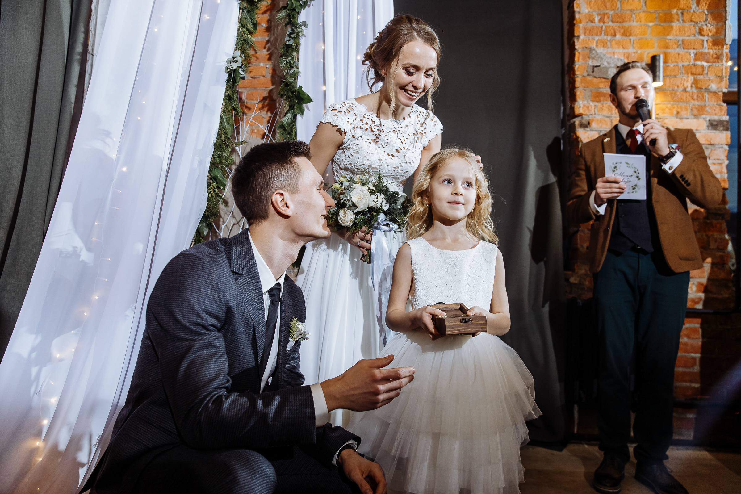 Floral girl with couple in city wedding venue, by Tanya Bogdan, Bude wedding photography.  