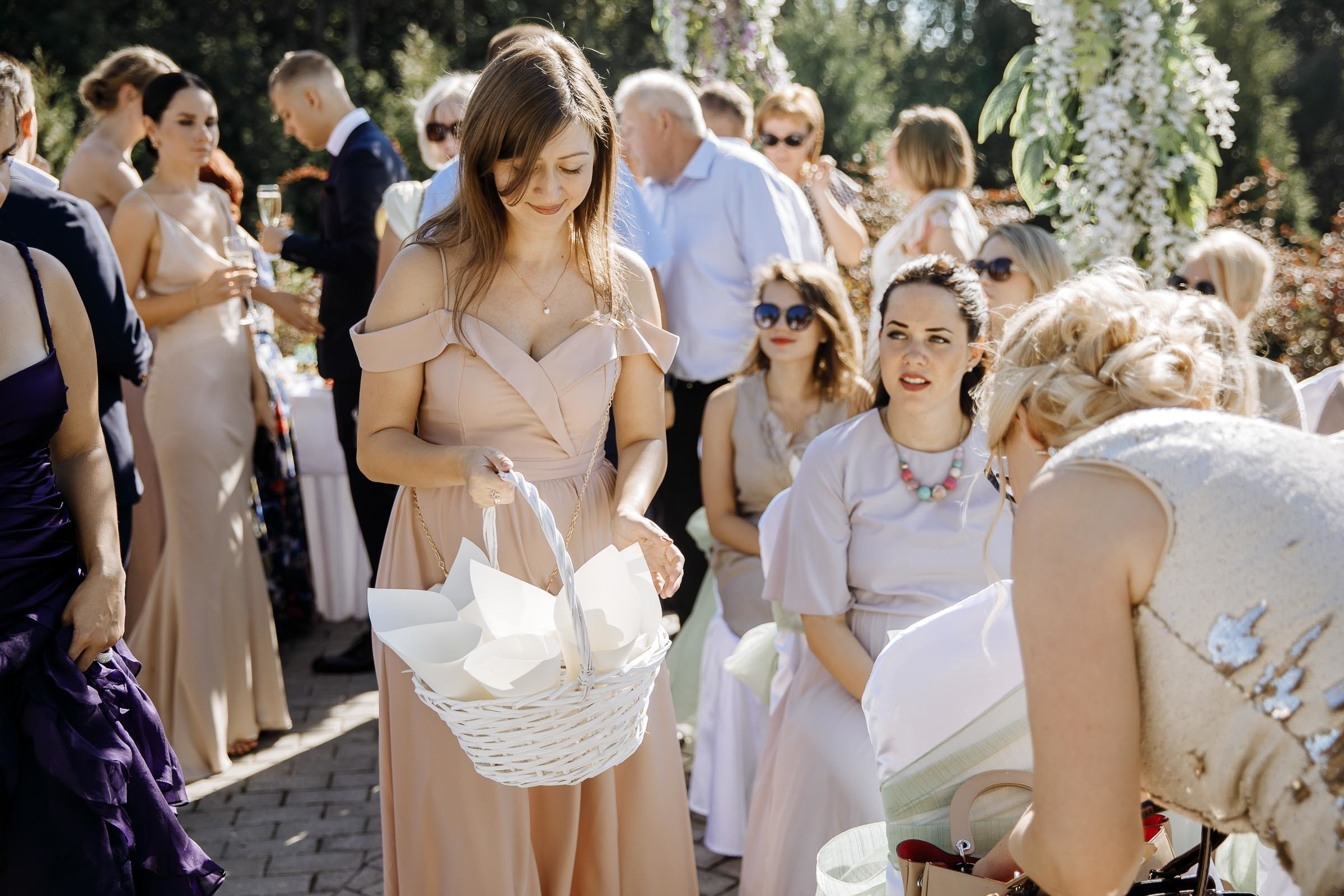 Guests taking seats in outdoor venue, by Tanya Bogdan, London wedding photographer.  