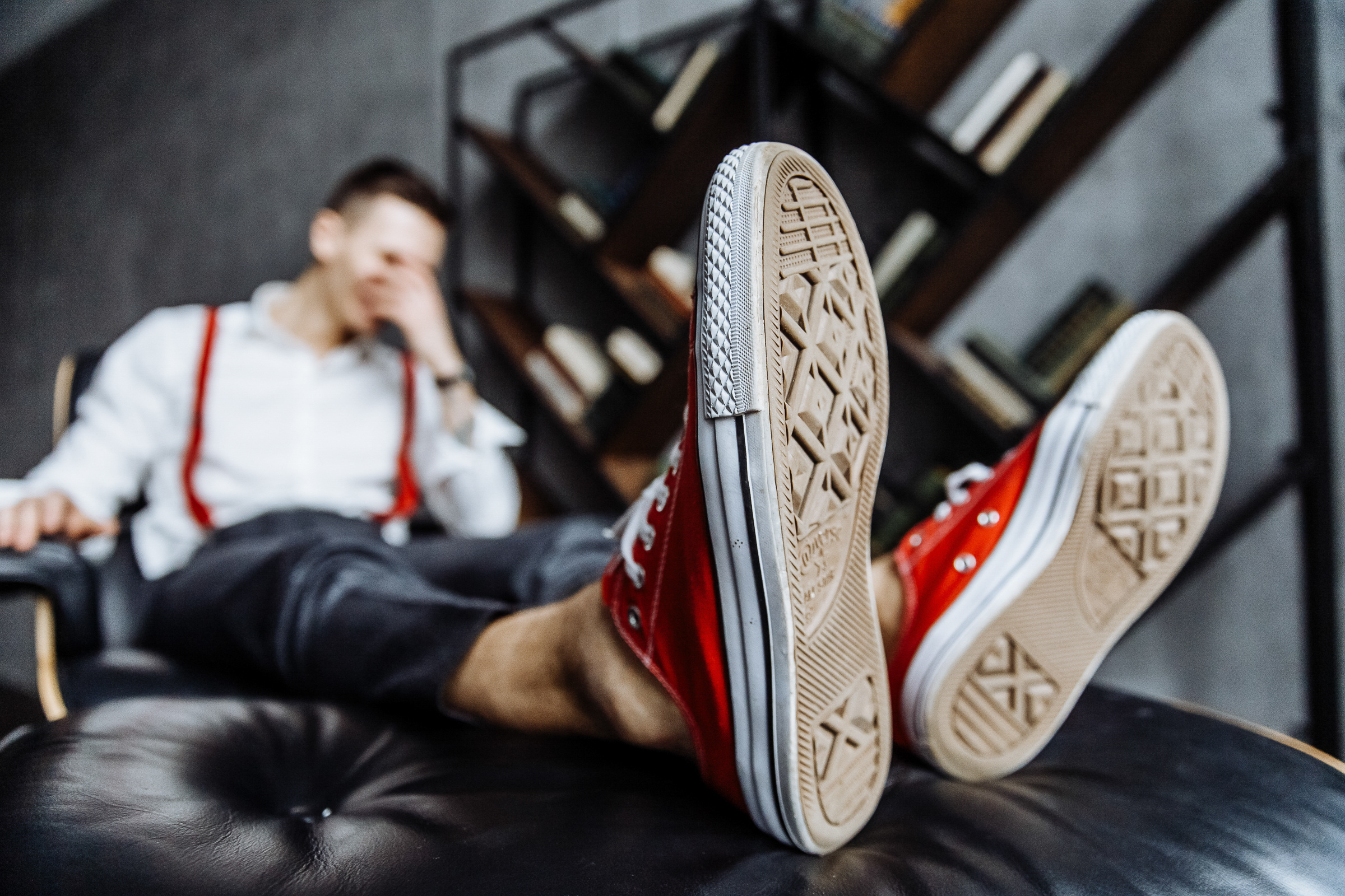 Groom in red Converse boots with feet up, by Tanya Bogdan, Bude wedding photographer.  