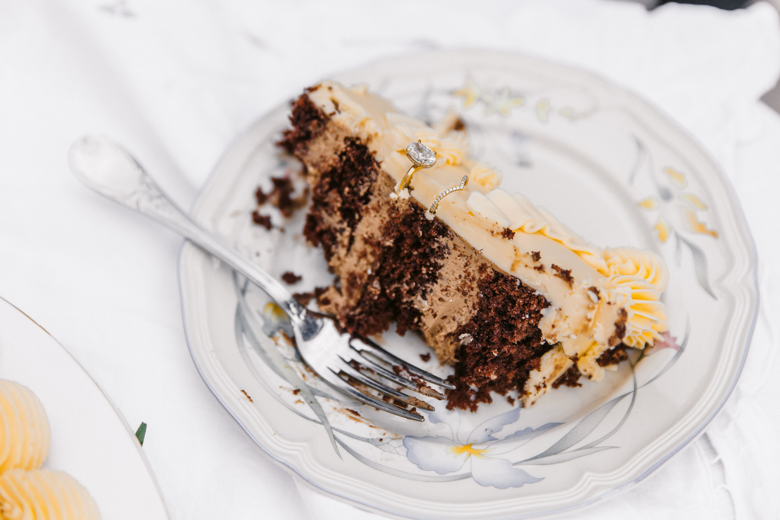 Stunning multi-tiered wedding cake decorated with fresh flowers and intricate icing designs, displayed at a France wedding