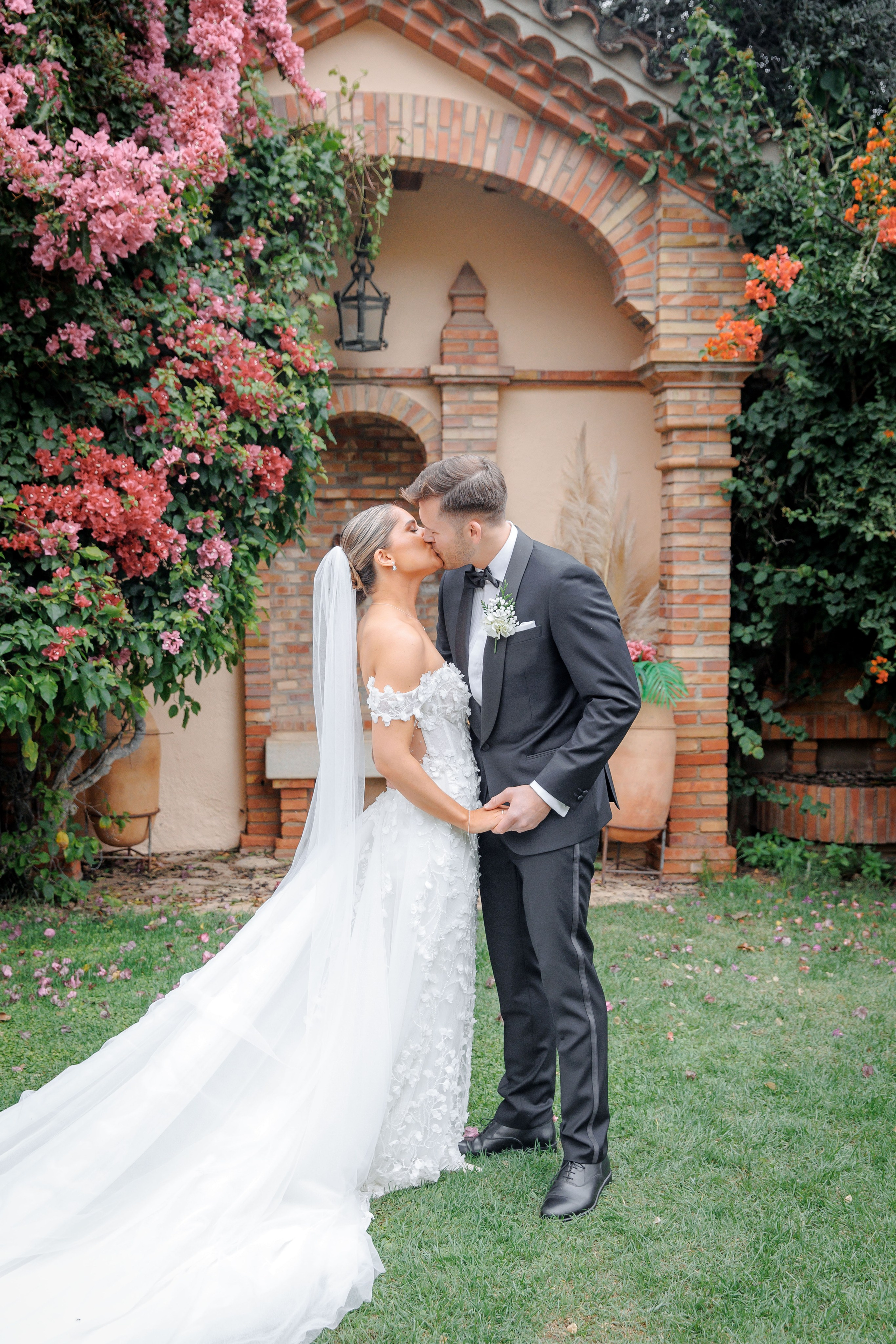 Bride embracing her groom in a romantic Barcelona wedding venue, capturing love and joy on their wedding day.