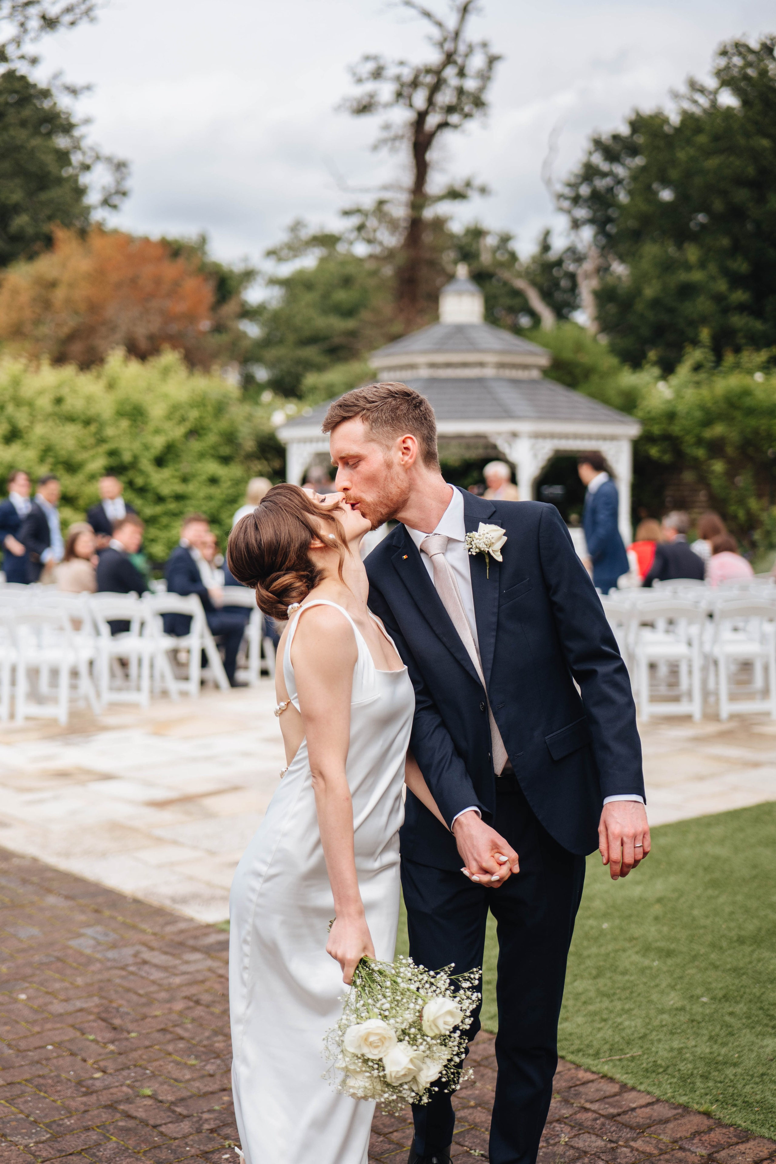 bride and groom kissing after the wedding ceremony