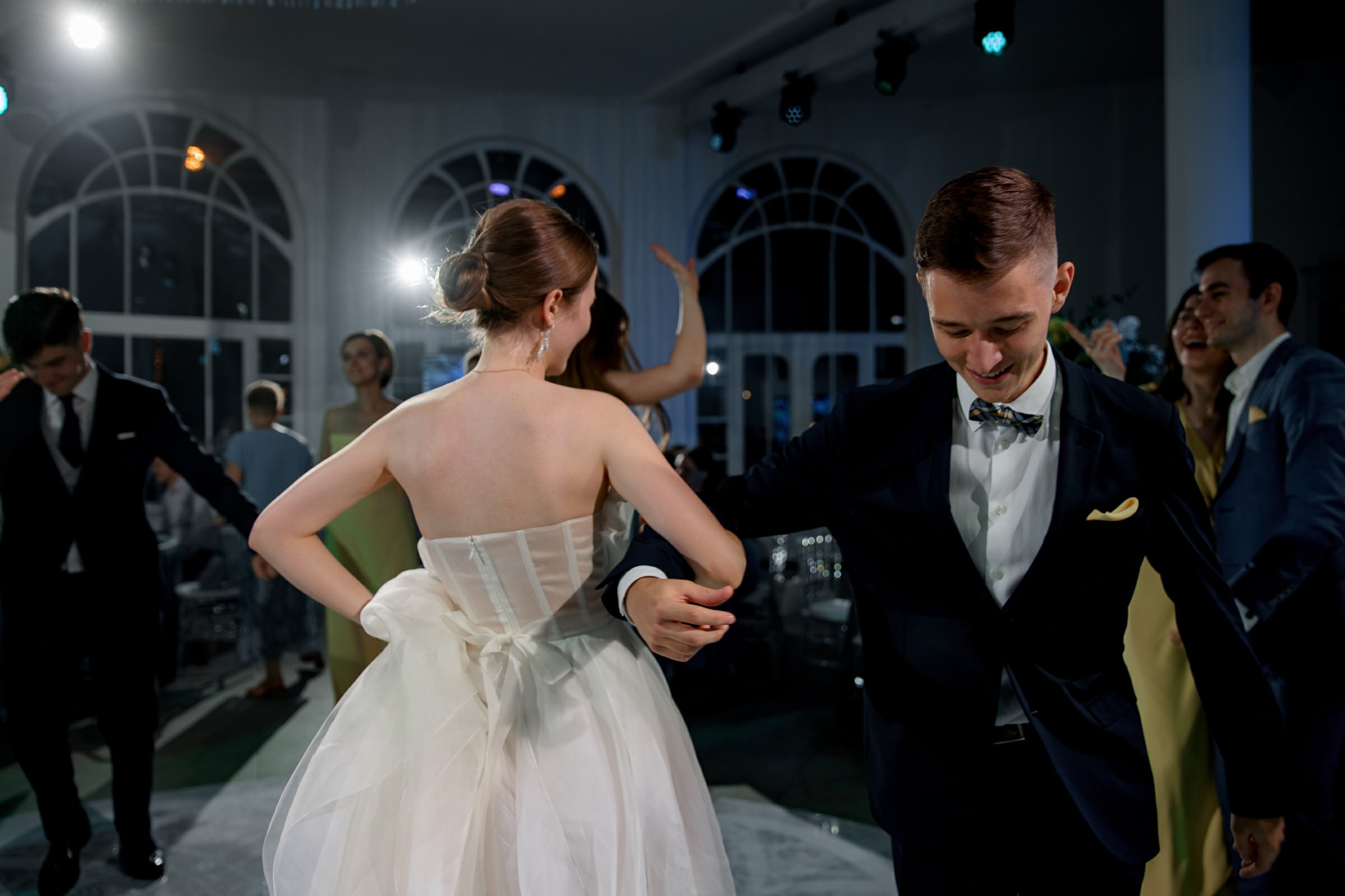 Bride dancing  with guest, by Cornwall reportage photographer.