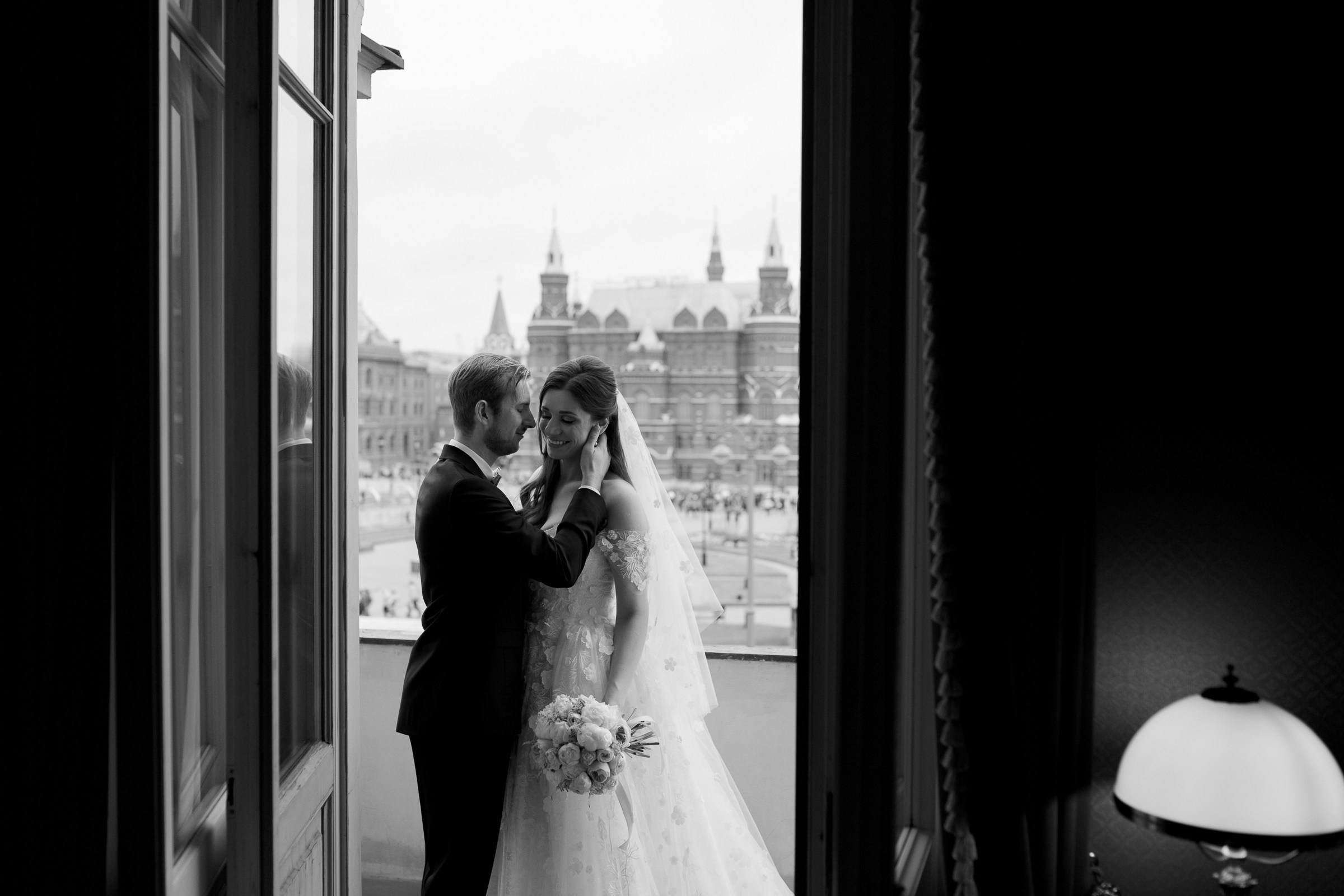 Groom with bride on balcony, by  Cornwall wedding photography, by Tanya Bodgan.