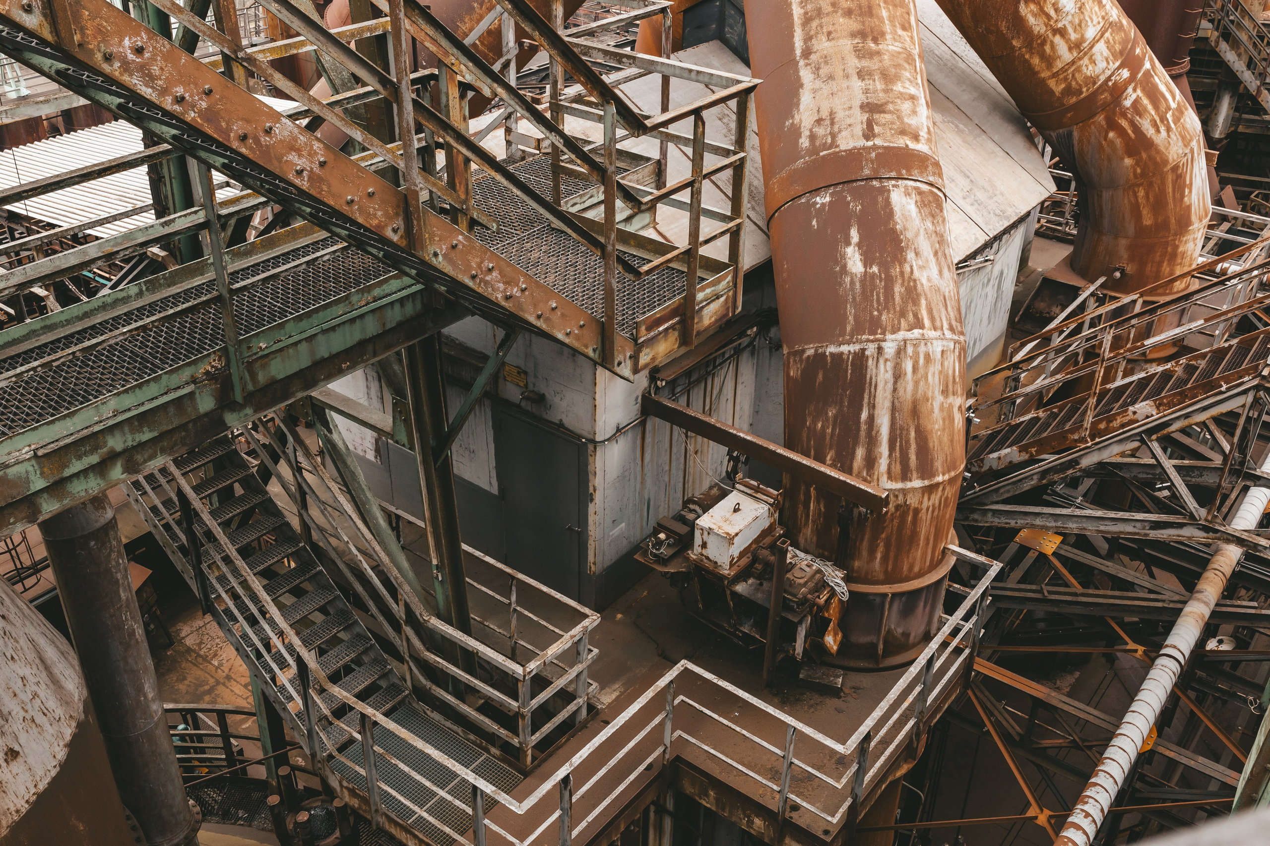 Переплетение труб и лестниц в глубине производственного корпуса.