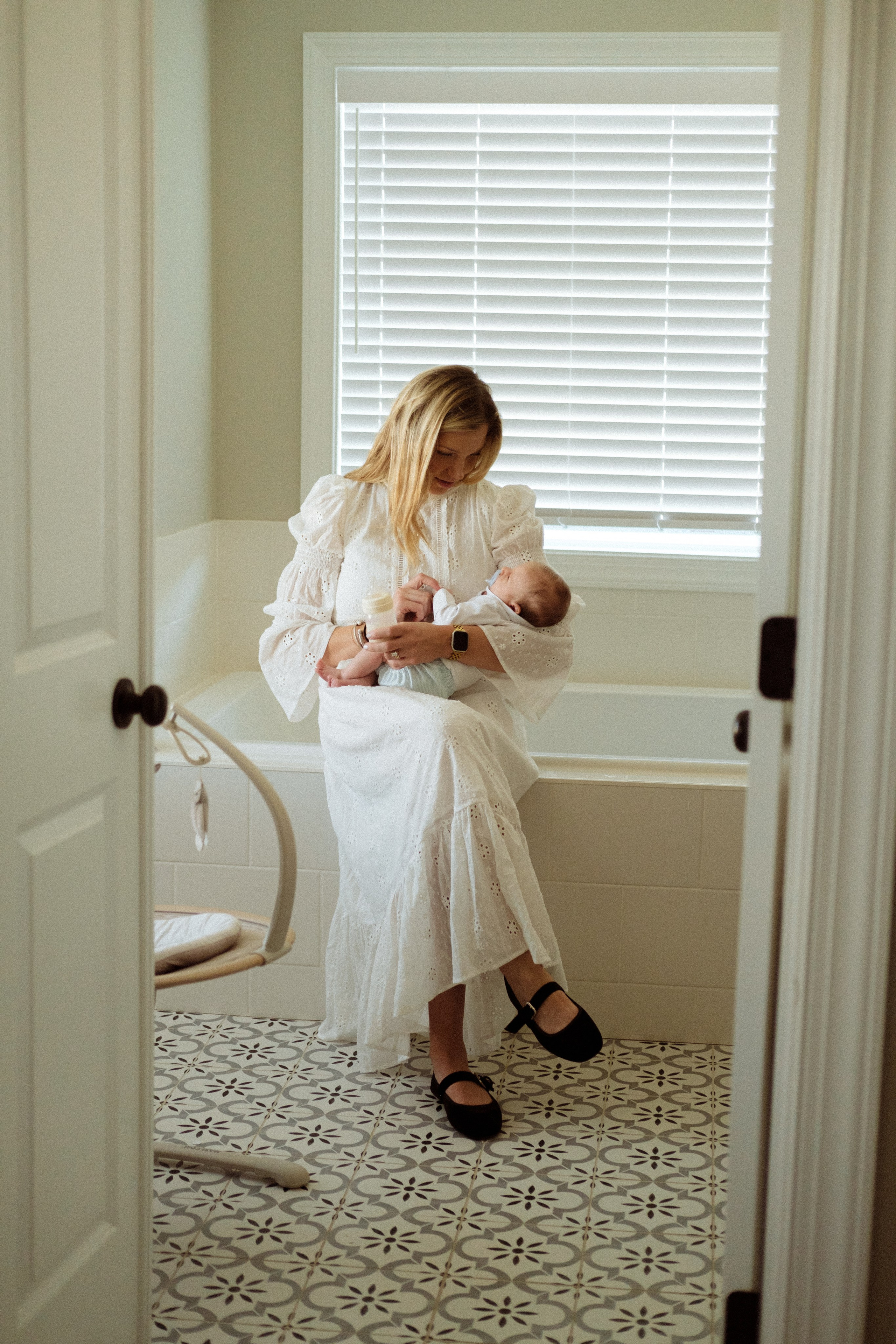 Woman feeding her newborn baby in the bathroom, photo taken in Richmond, VA