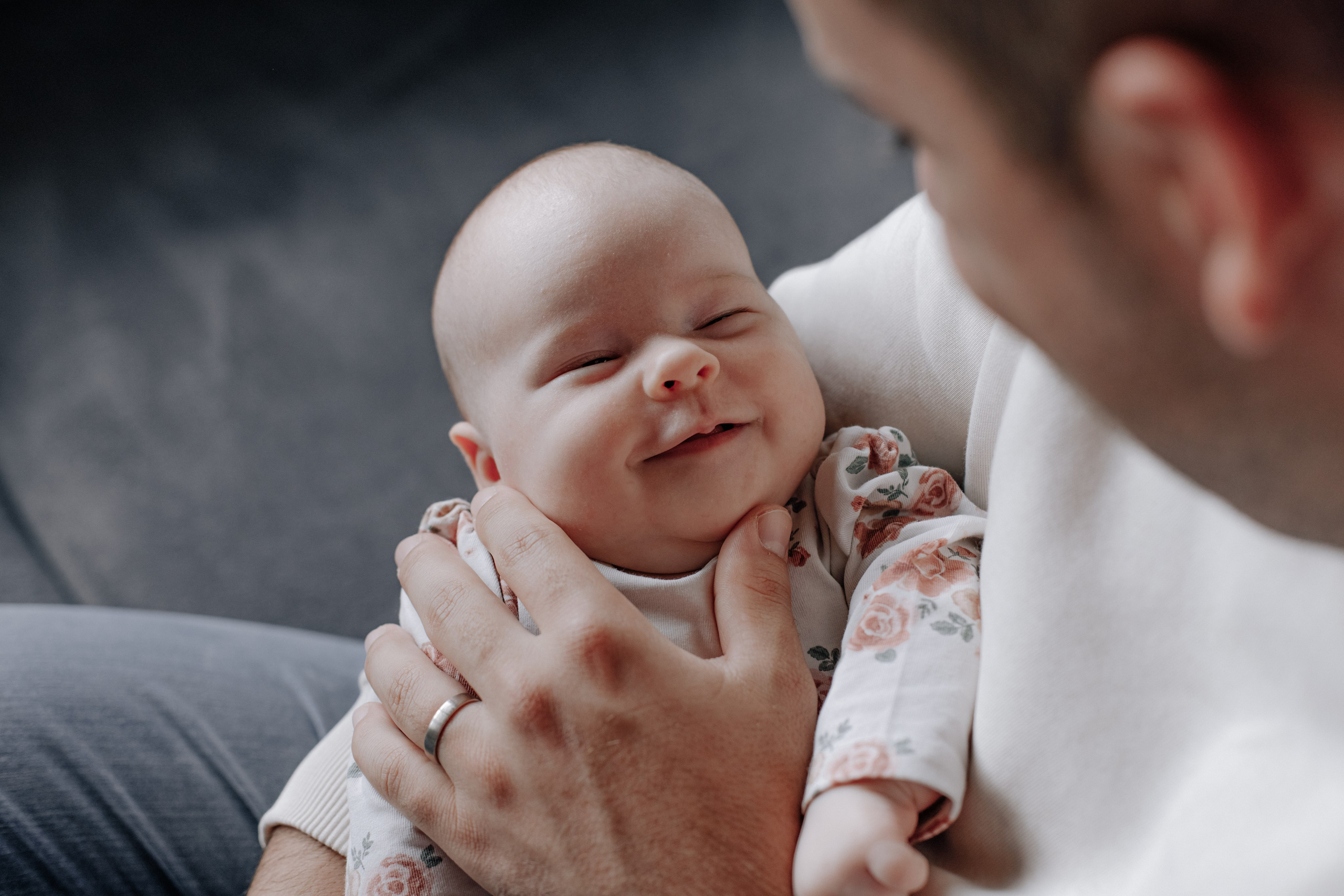 Baby lächelt liebevoll zum Papa.
