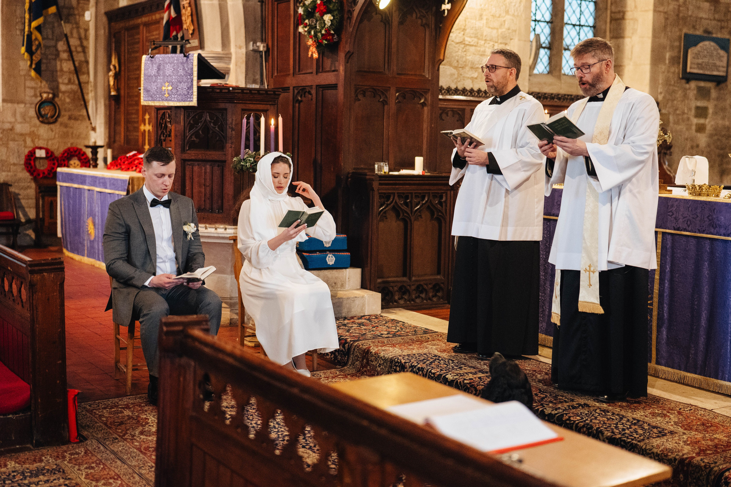 ceremony in church, bride and groom sitting