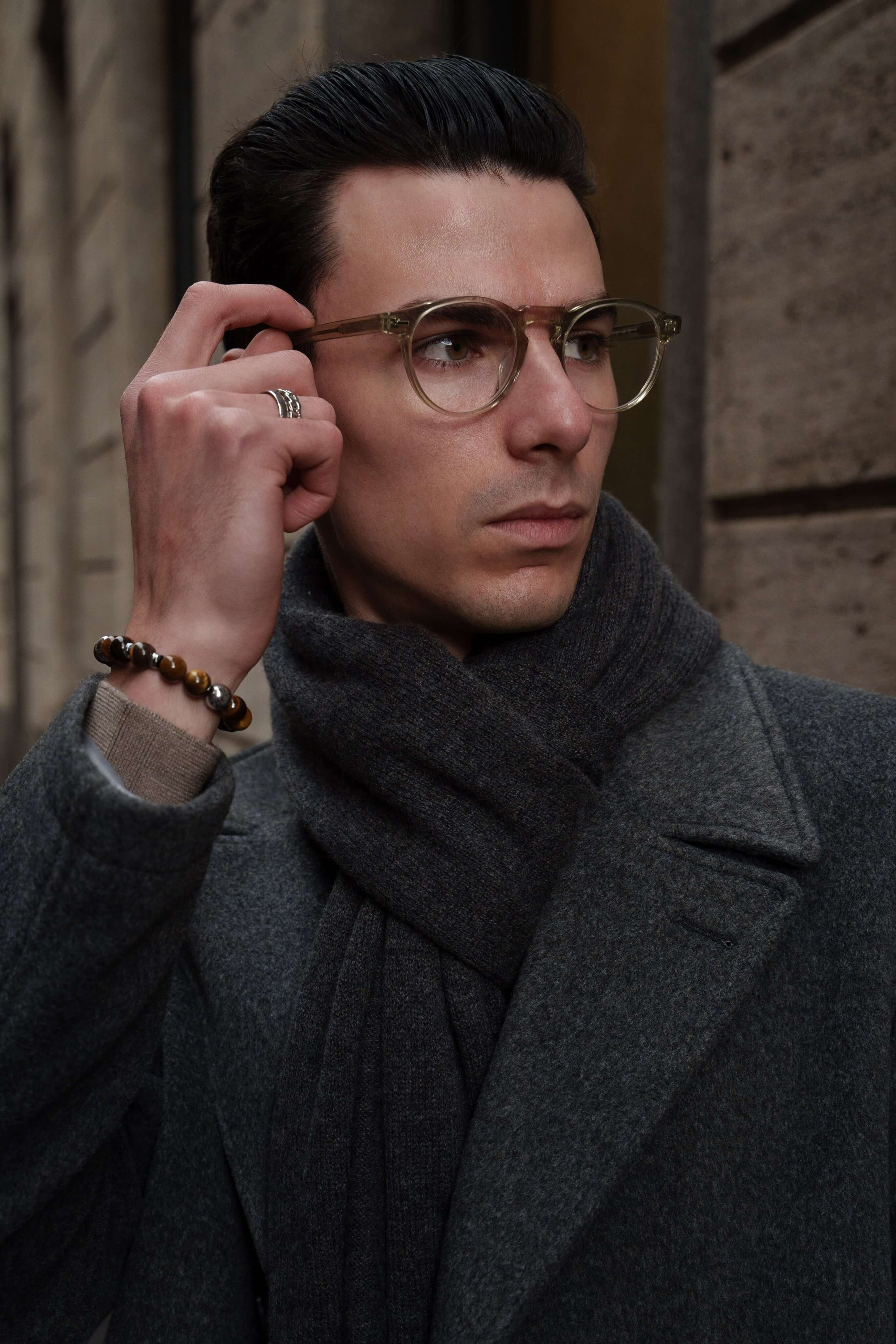 Close-up of men's transparent eyeglasses and accessories during fashion shoot in Milan