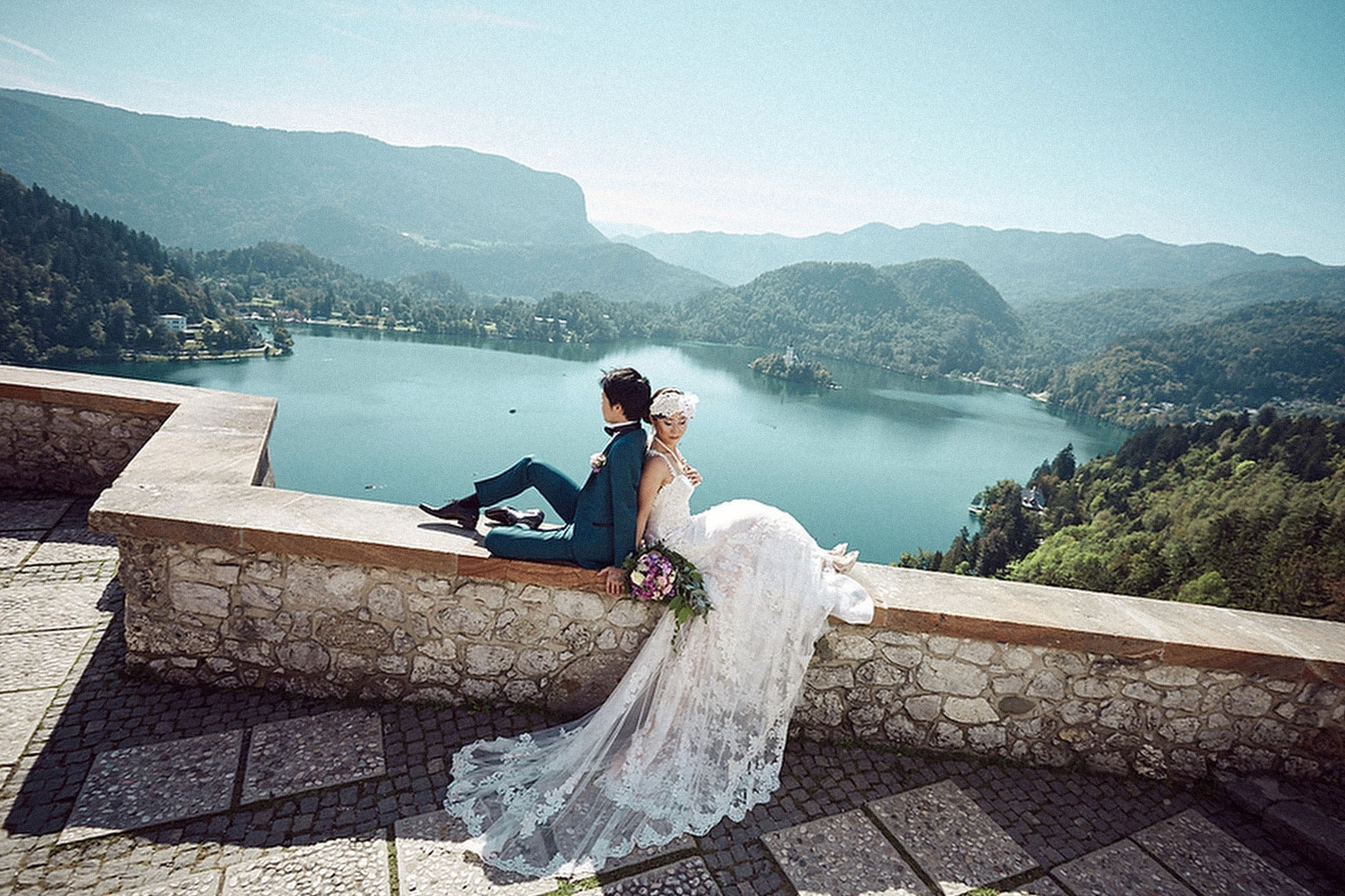 Newlyweds admiring Lake Bled from Bled Castle's overlook