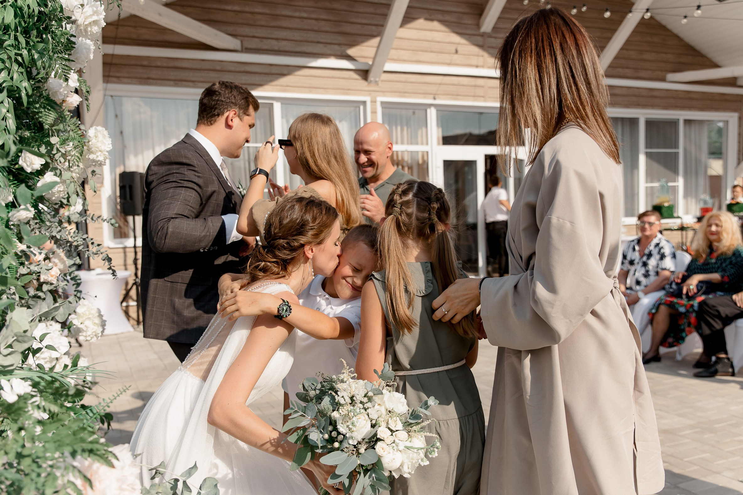 Guests congratulations by riverside, by Tanya Bodgan, Bude, Cornwall wedding photographer.