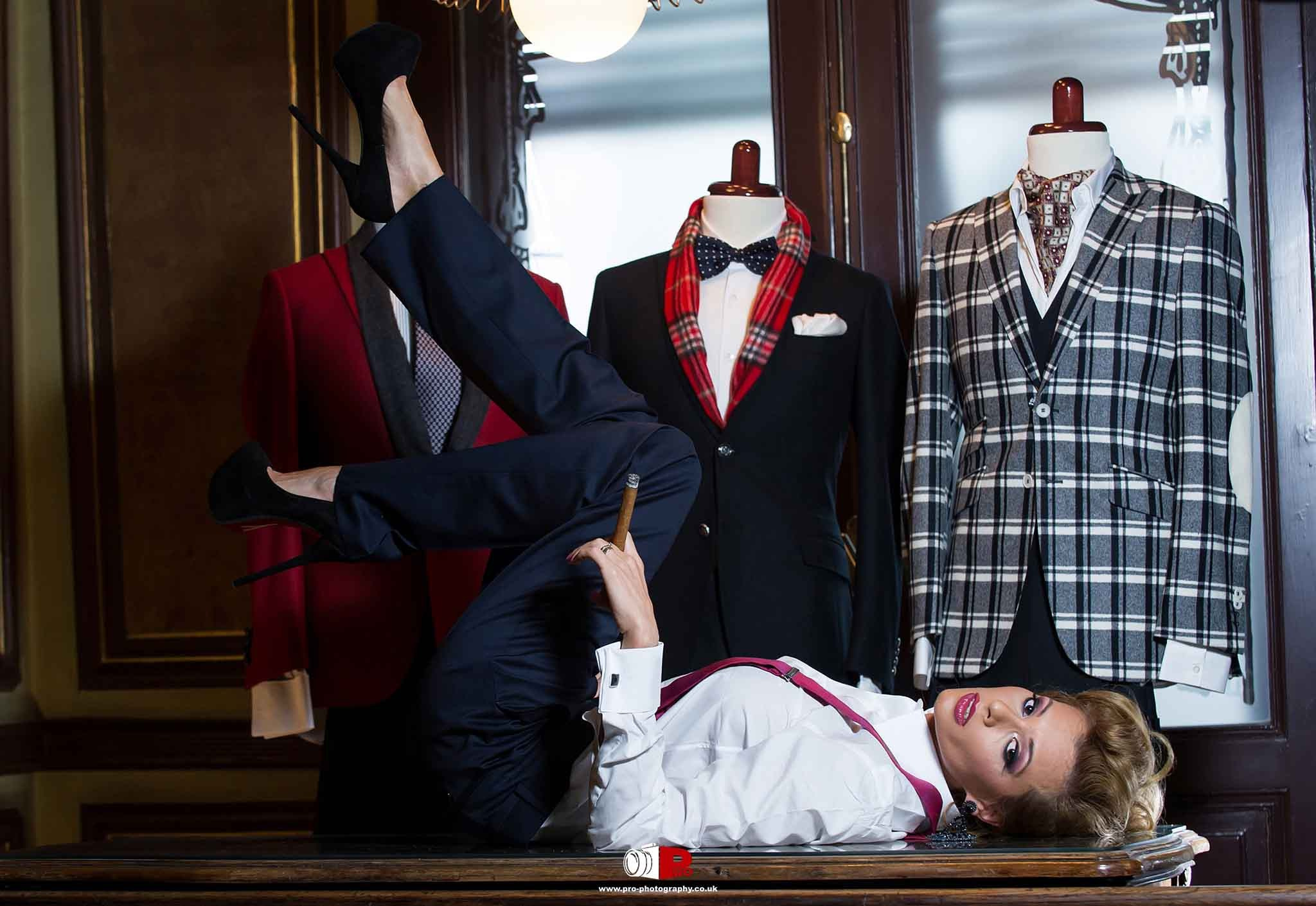 Fashionable model posing with tailored suits in a vintage setting.
