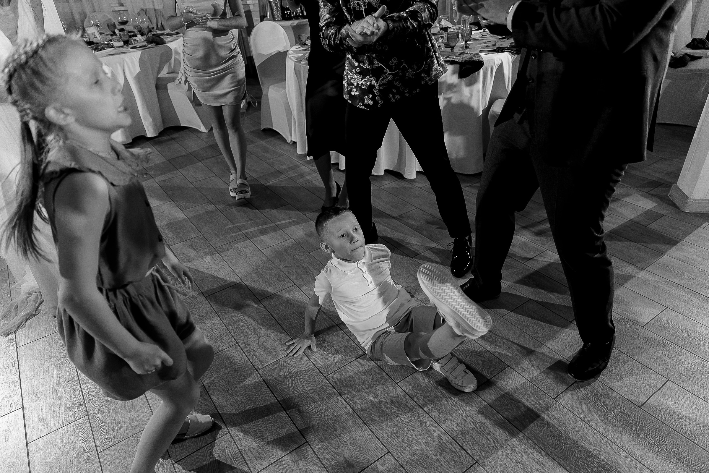 Guests in lively dance, by Cornwall editorial wedding photographer.