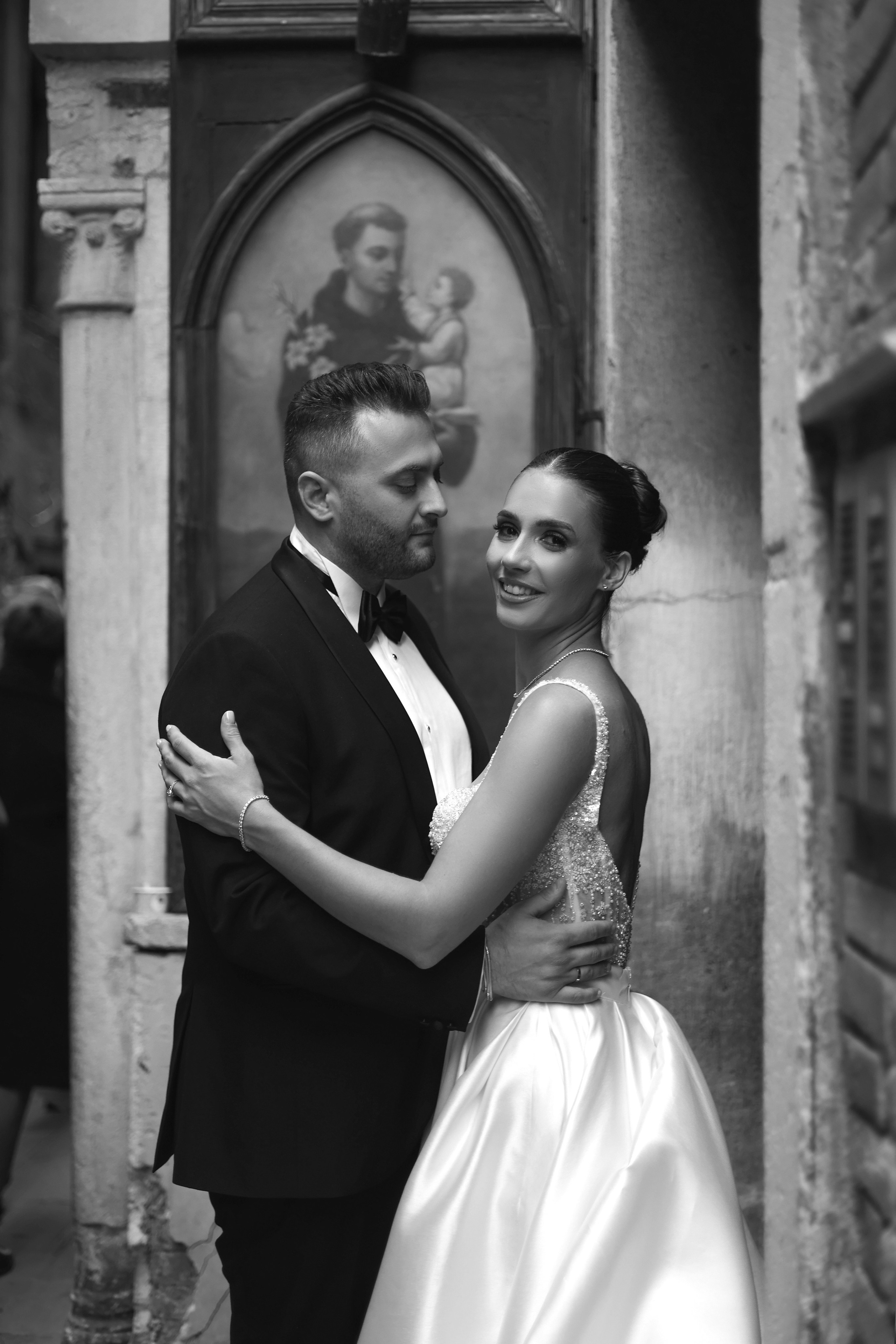 Bride and groom standing on a picturesque Venice square