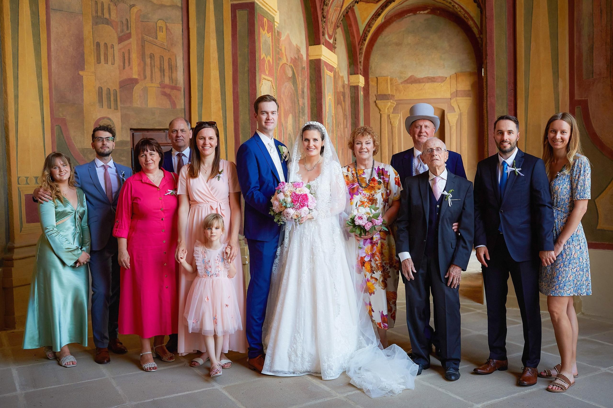 A portrait of the bride & groom and their close family members  is captured against the bacdrop of the Ledebour Garden's historic paintings.