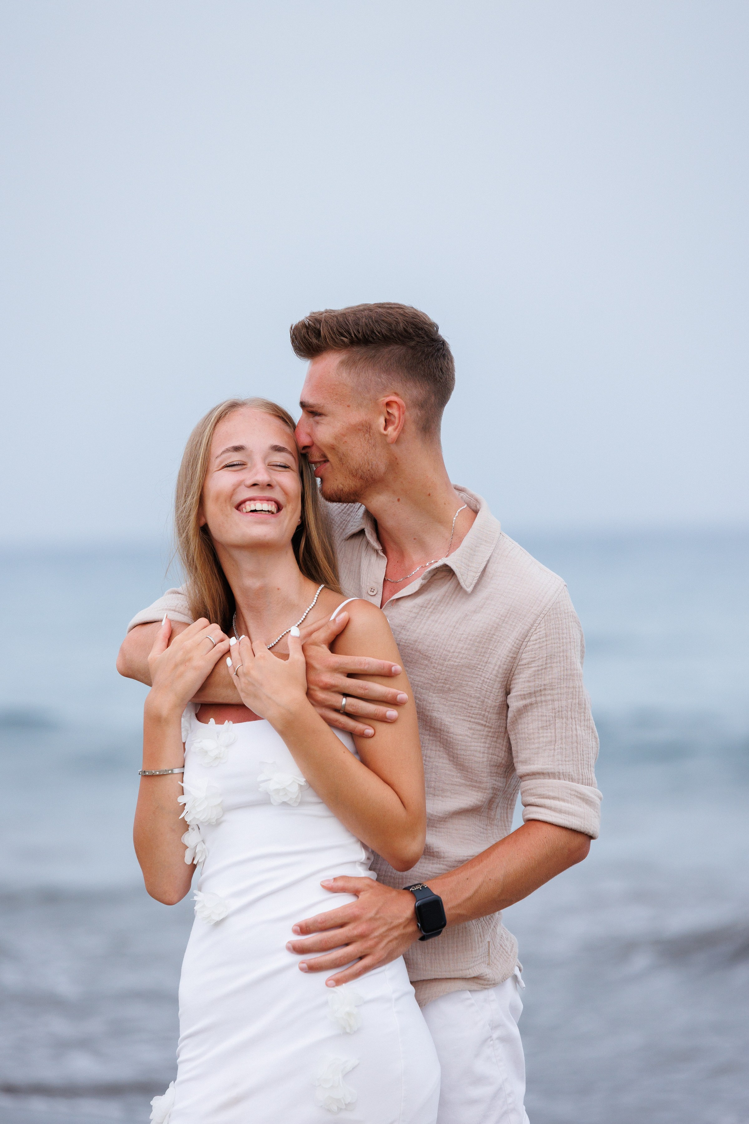 Couple on dunes at sunset love vacation by Slavik Robtsenkov