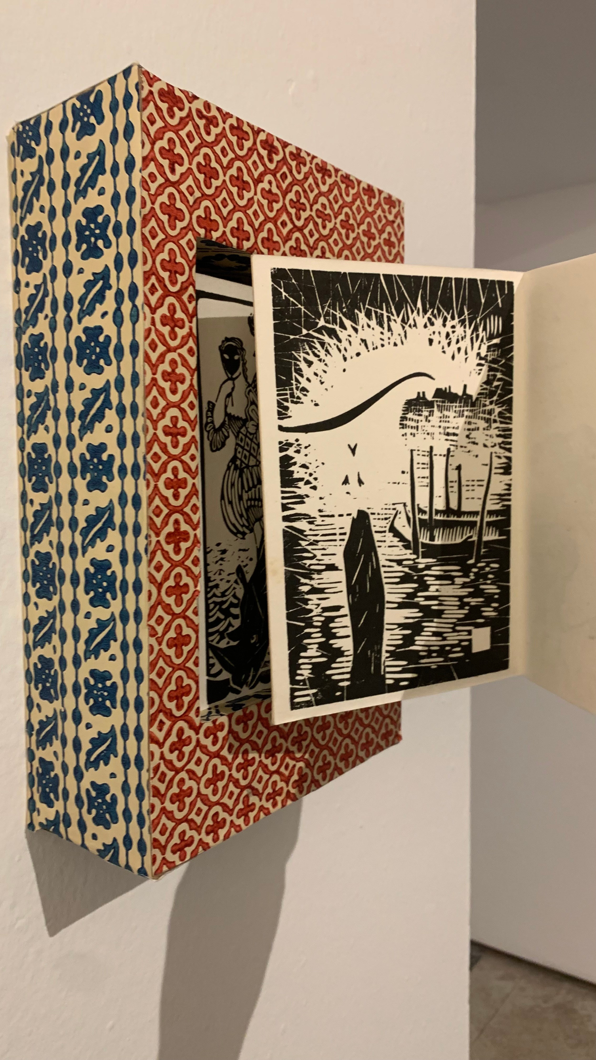 Artist book hanging on wall, collection