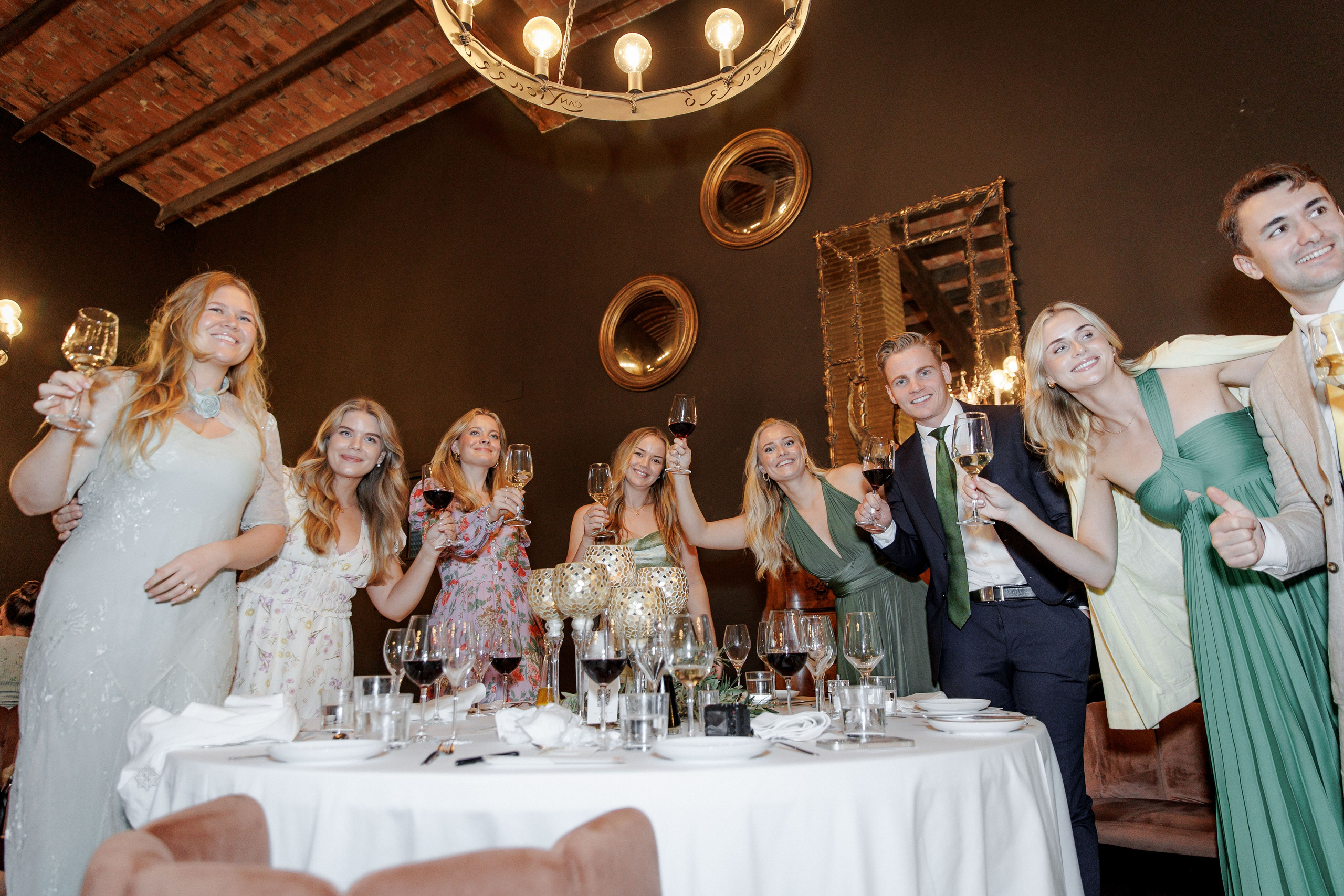 Friends toasting with champagne glasses at a wedding reception in Barcelona, capturing moments of joy and friendship.