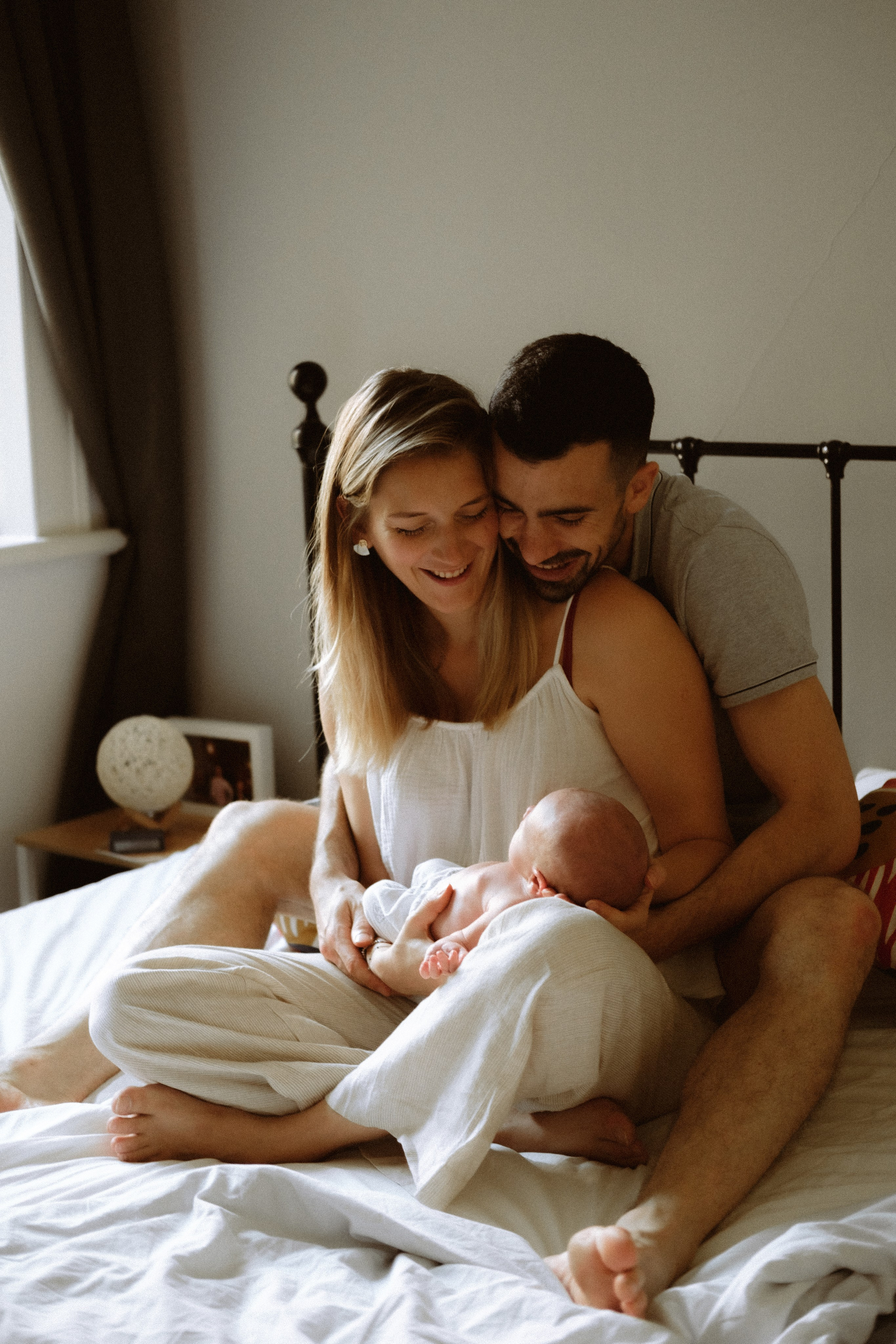 Tender moment of parents gazing at their newborn with love and wonder in Richmond, VA.