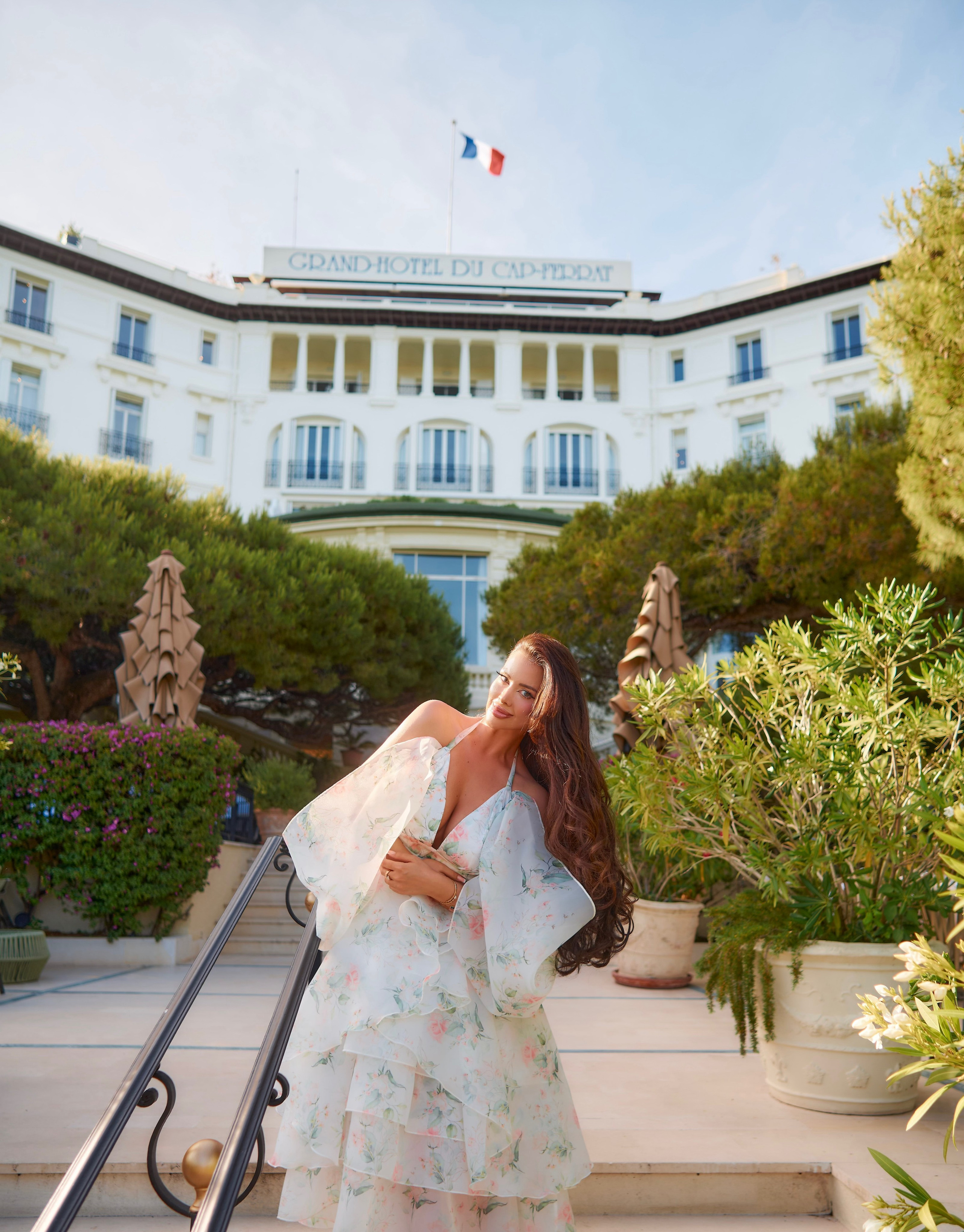Fashion portrait of model in flowing dress with iconic Grand Hotel Cap Ferrat view