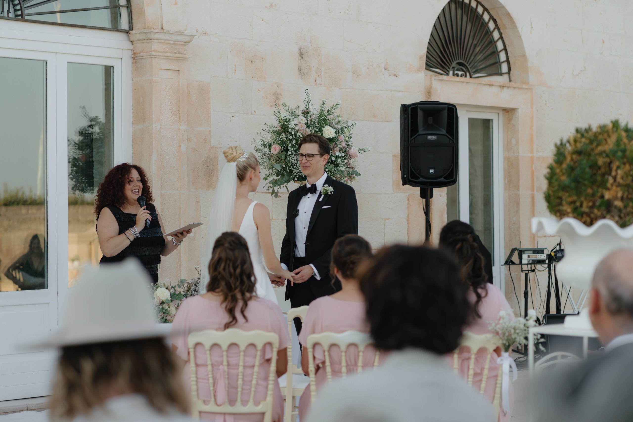 Bride and groom exchanging vows in courtyard of Masseria Traetta Exclusive