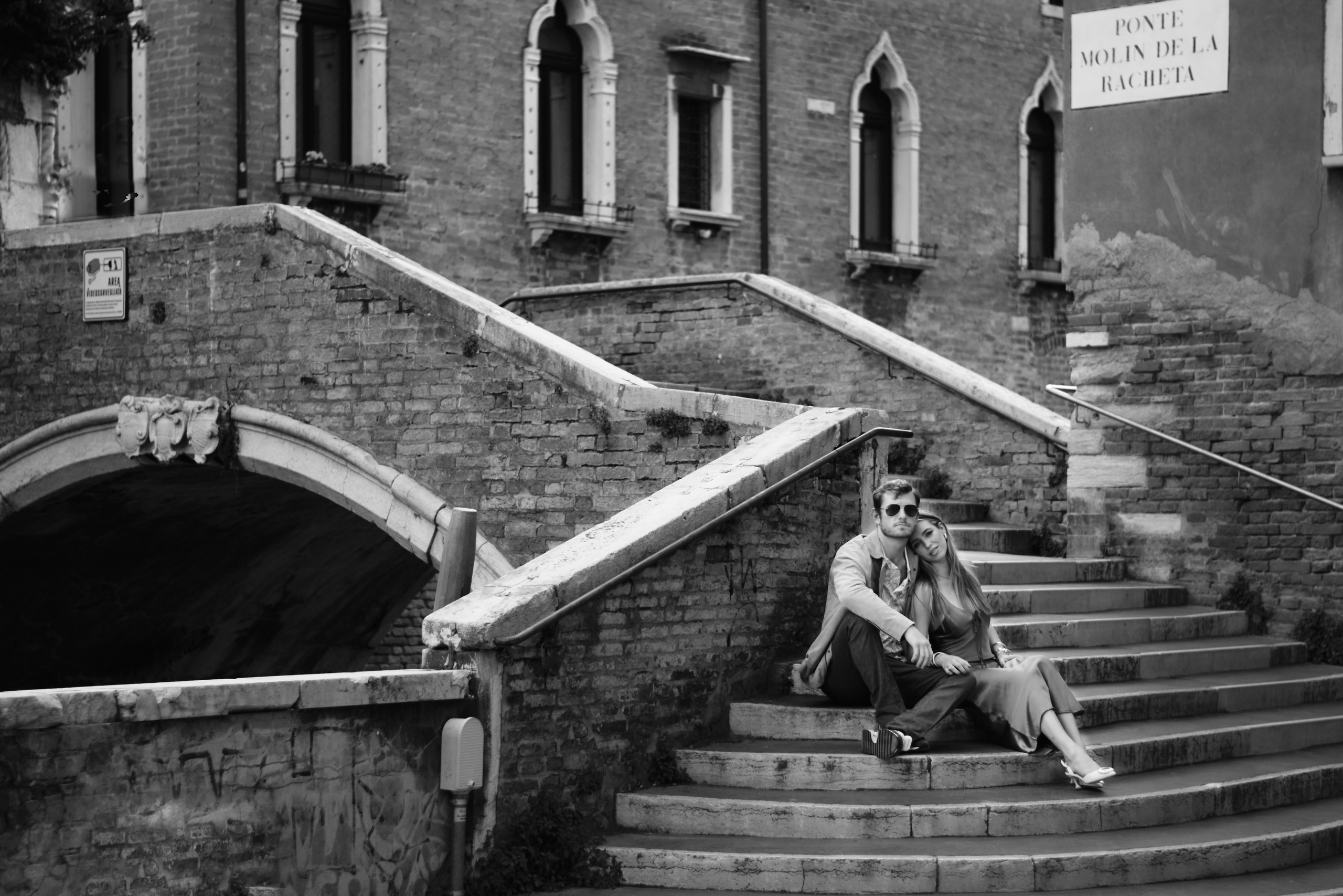 With every step, the photographer captures their genuine smiles and spontaneous moments. The narrow streets serve as a charming backdrop, creating an intimate atmosphere that reflects the uniqueness of their love.As they walk, they pause occasionally to embrace in a tender hug or steal a playful kiss. The intertwining streets seem to mirror their connection, each turn revealing a new moment of joy and affection.