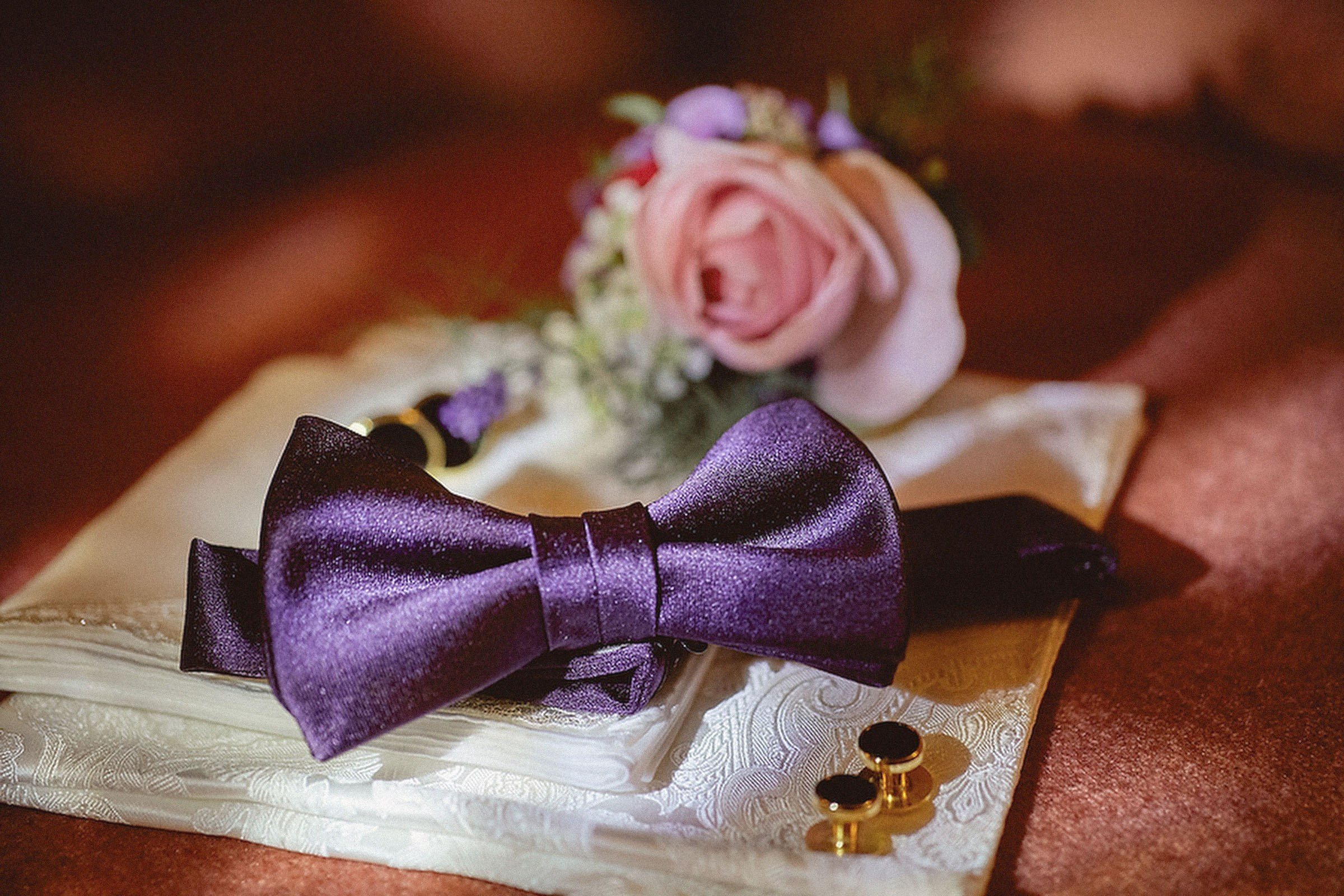 Groom's accessories - bow tie, cuff links, and boutonniere displayed at Vila Bled, Slovenia