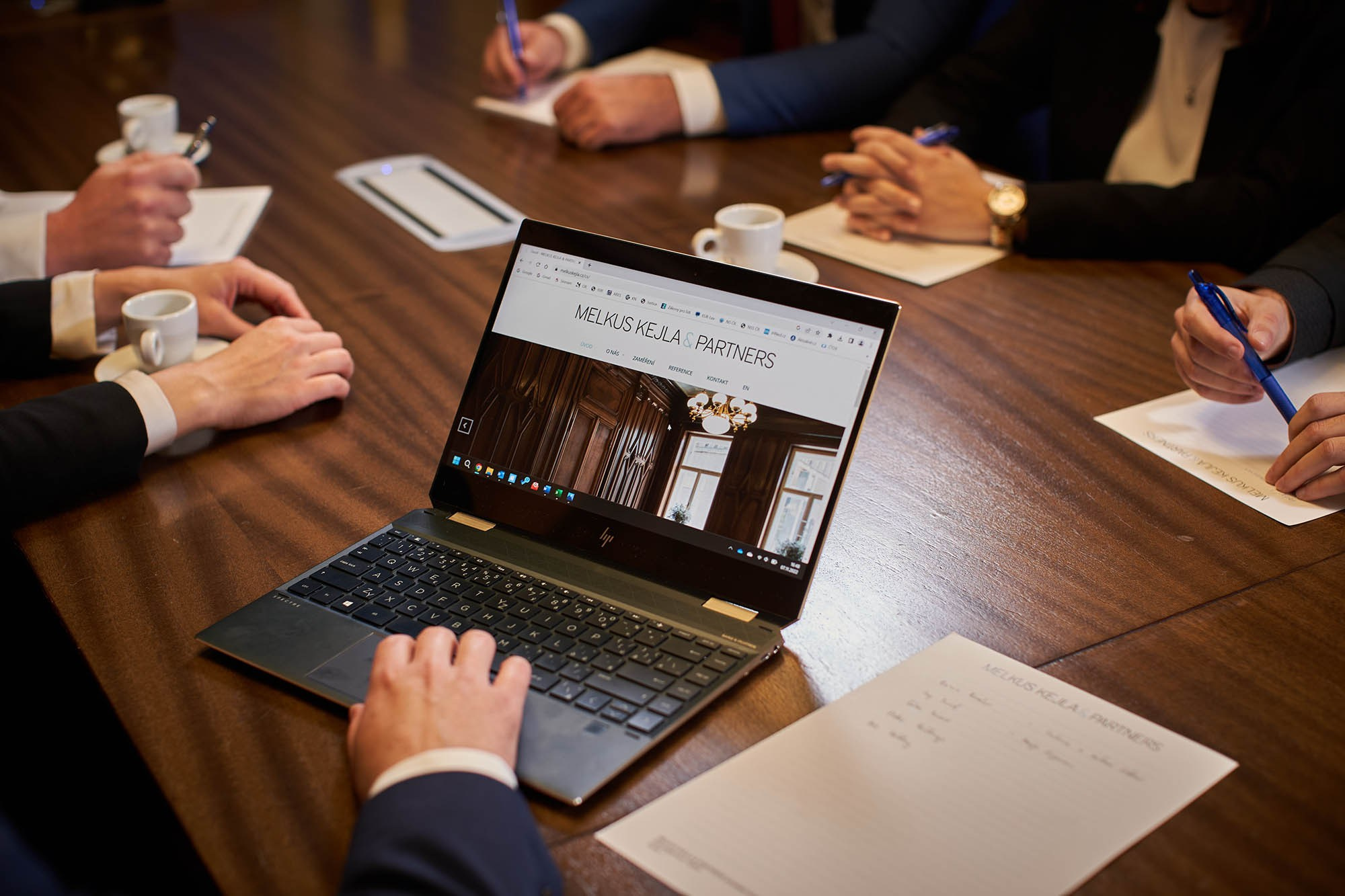 A PR photo of employees around a table at a law firm.