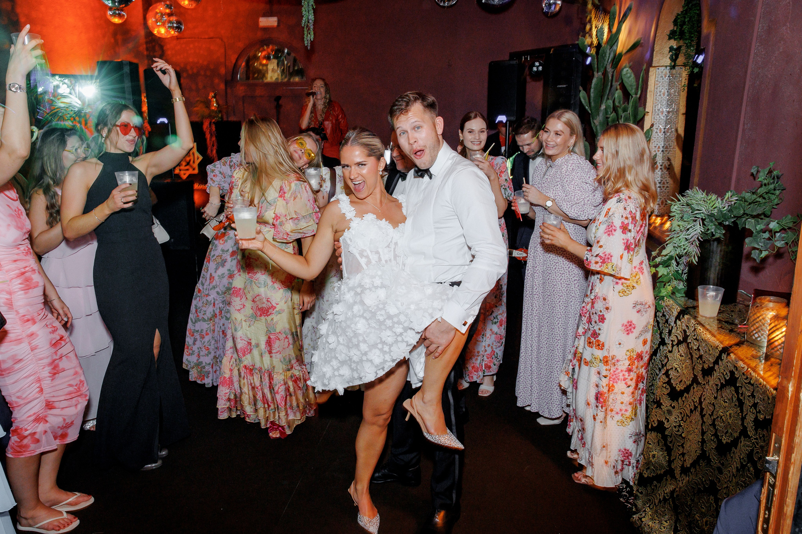Newlyweds sharing their first dance at a Barcelona wedding, surrounded by family and friends in a joyous celebration.