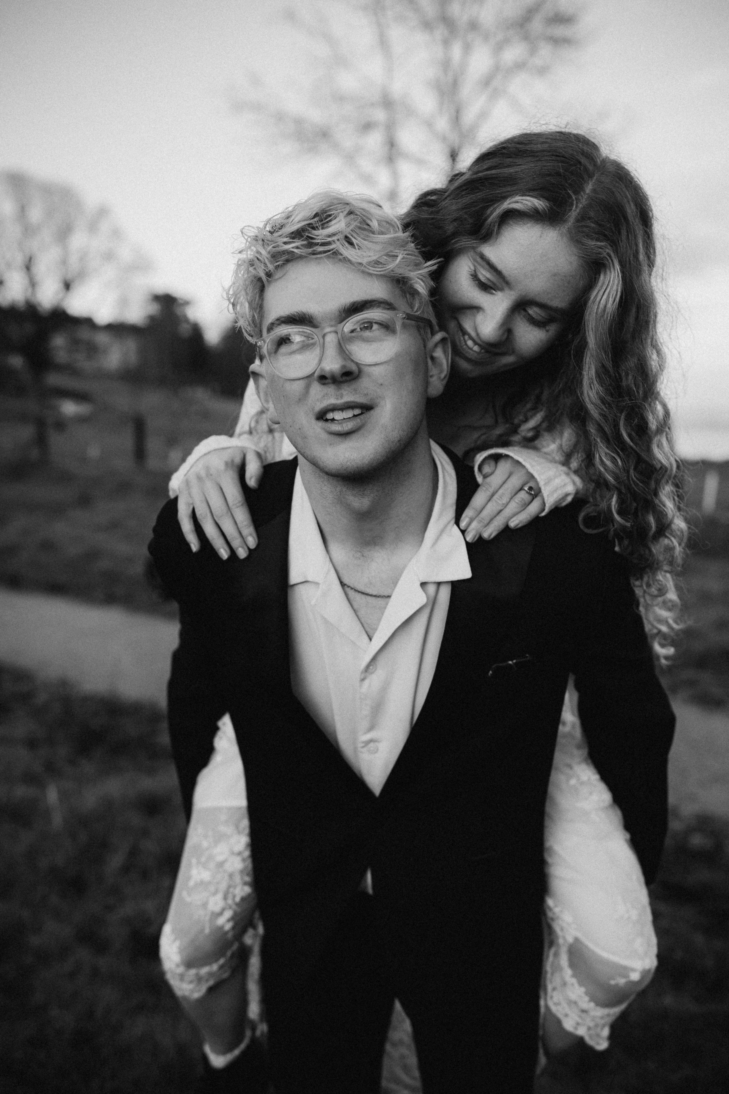 man carries woman on his back black and white photo