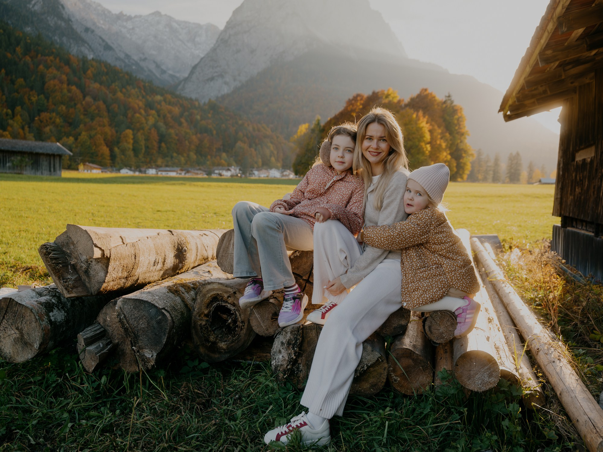 Girl hugging her parents during a heartfelt family moment in the Bavarian Alps near Garmisch-Partenkirchen