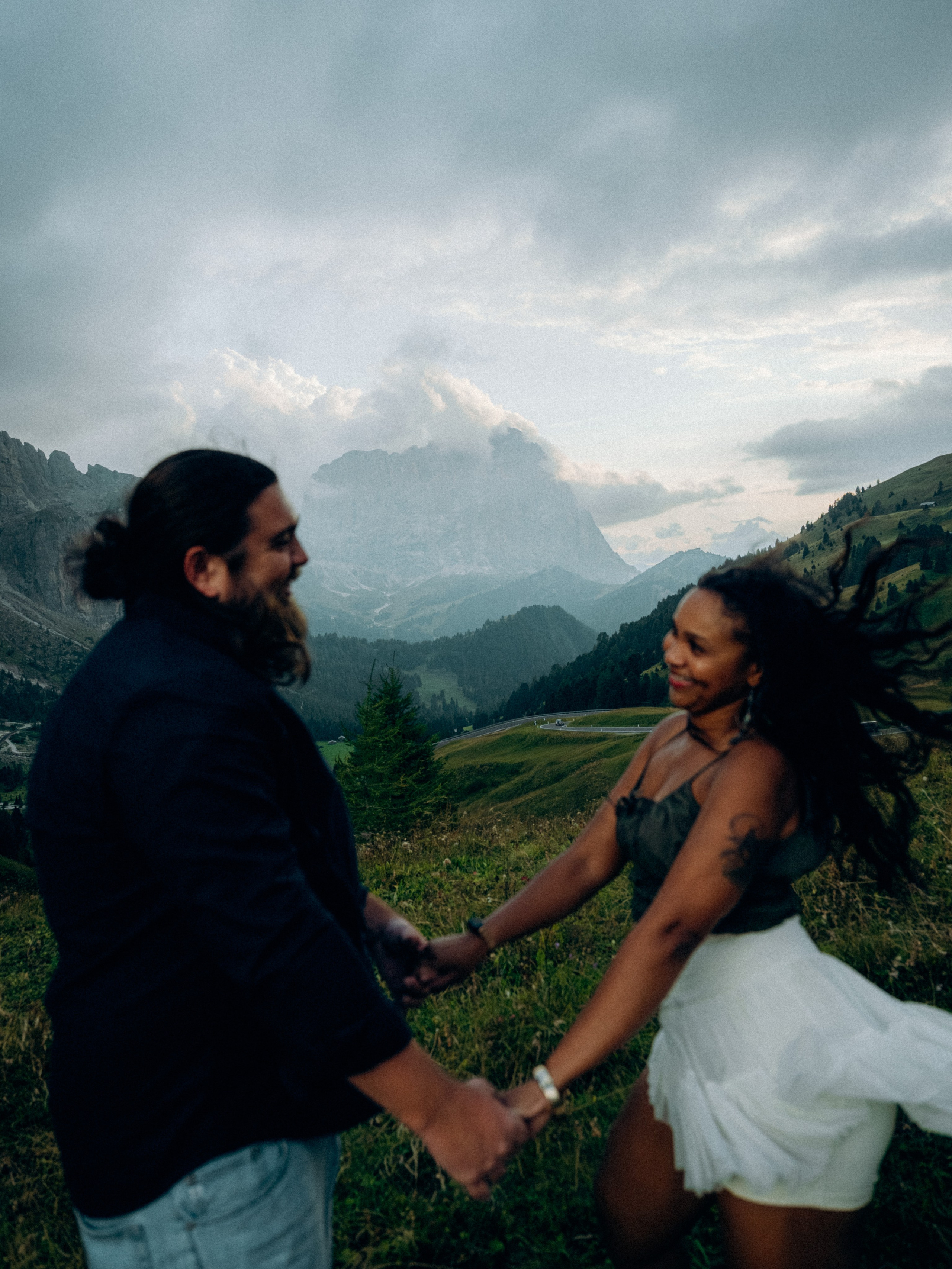 Engagement photo in Ortisei with warm mountain light and Dolomite peaks