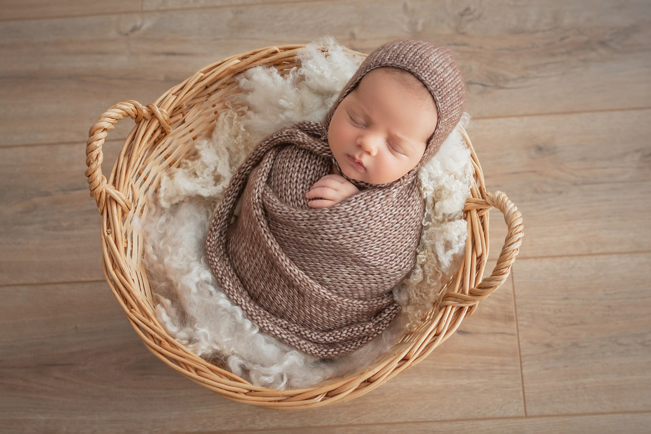 Newborn basket pose with layered wrap cocoon technique