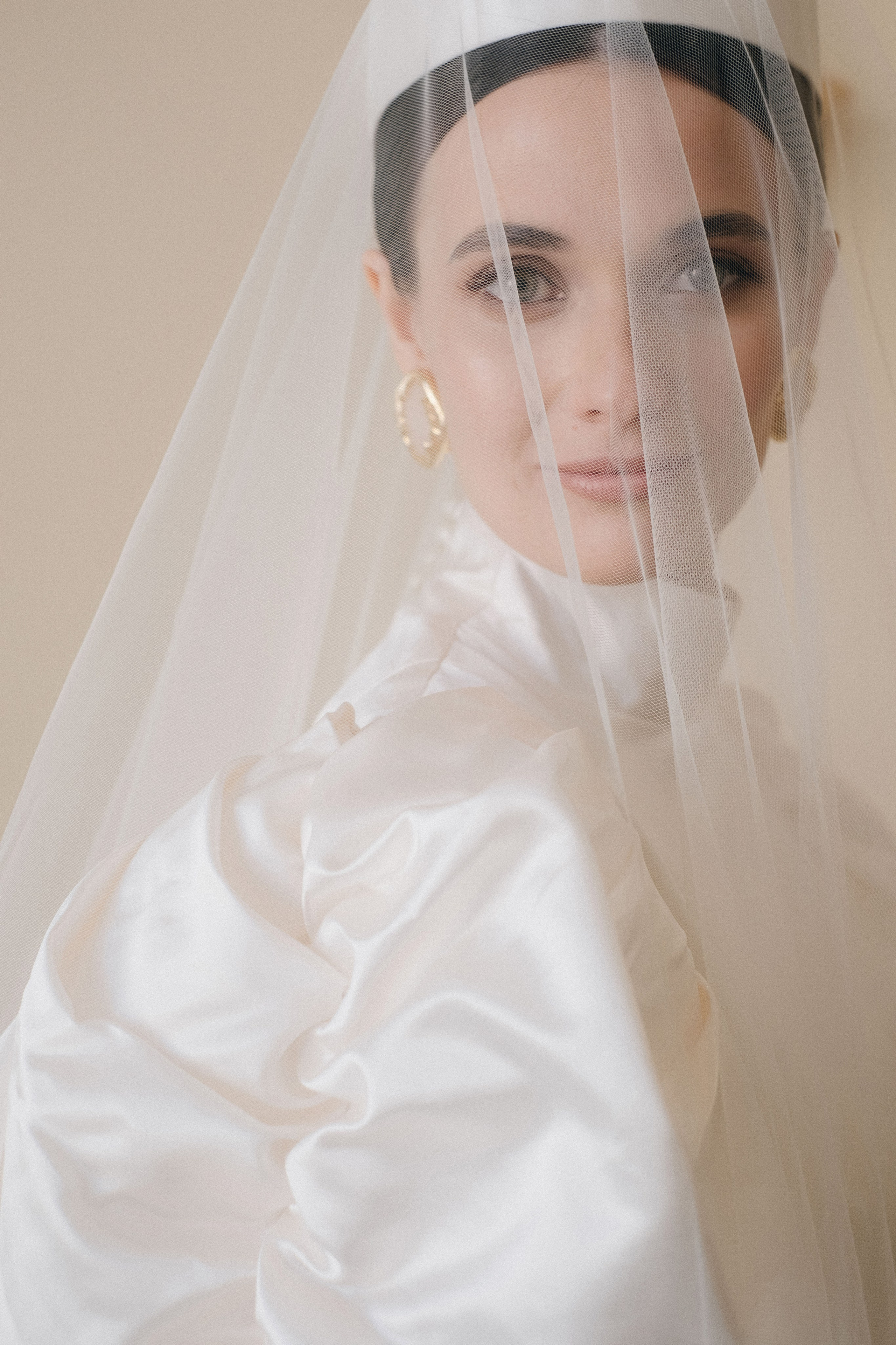 Bride looking over shoulder in chic editorial portrait