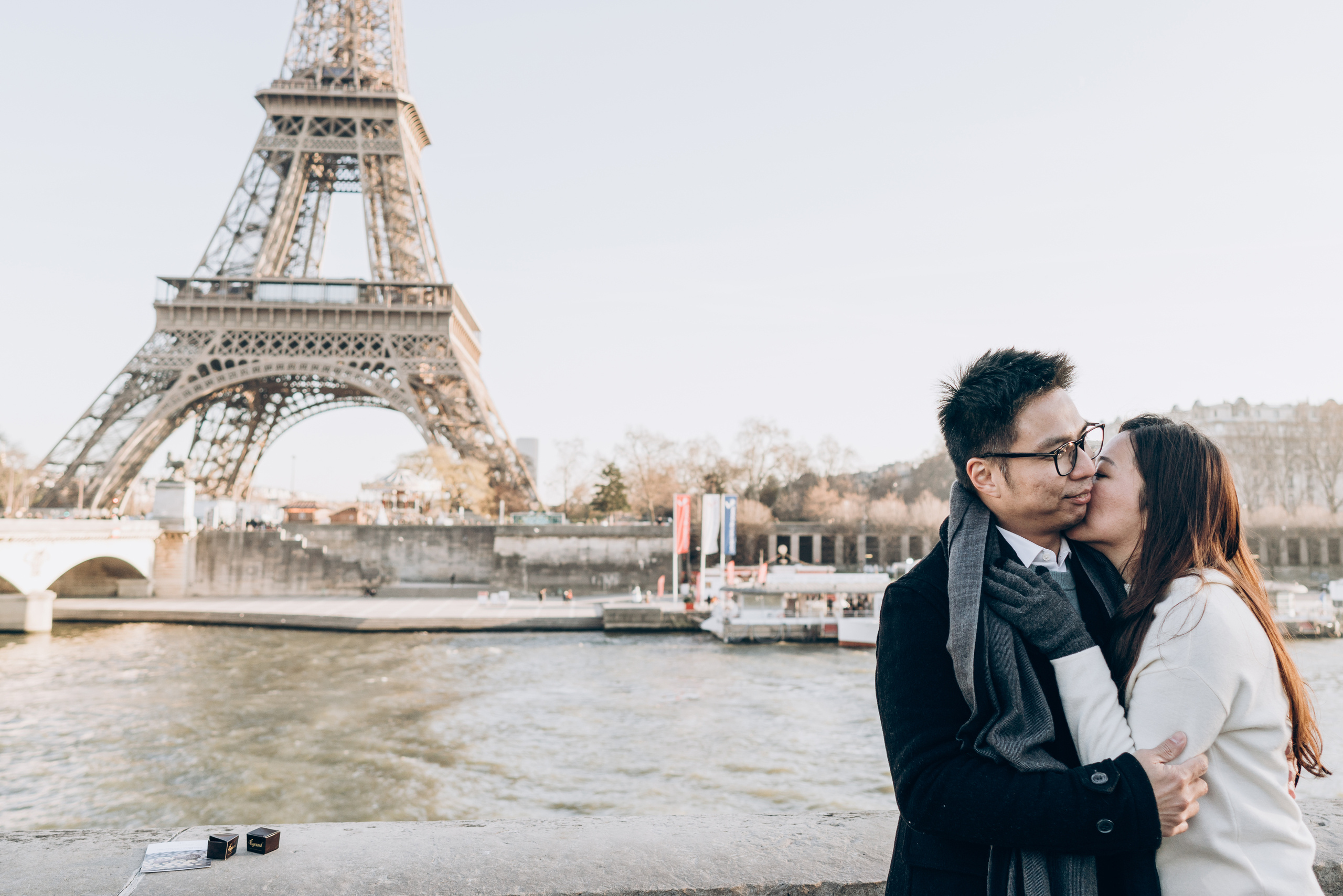 young Chinese couple kissing with tower bridge on background 