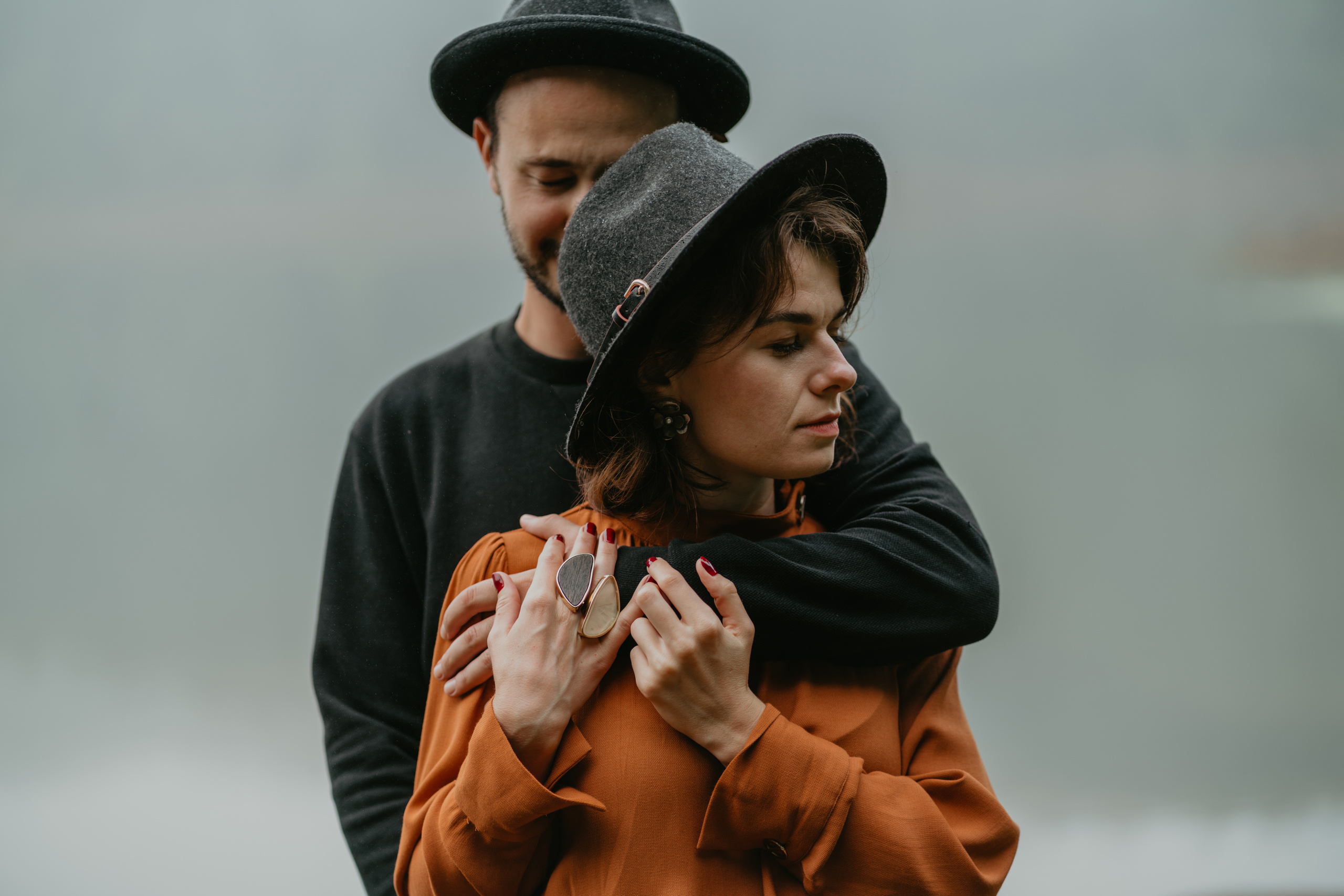 couple standing by the foggy lake 