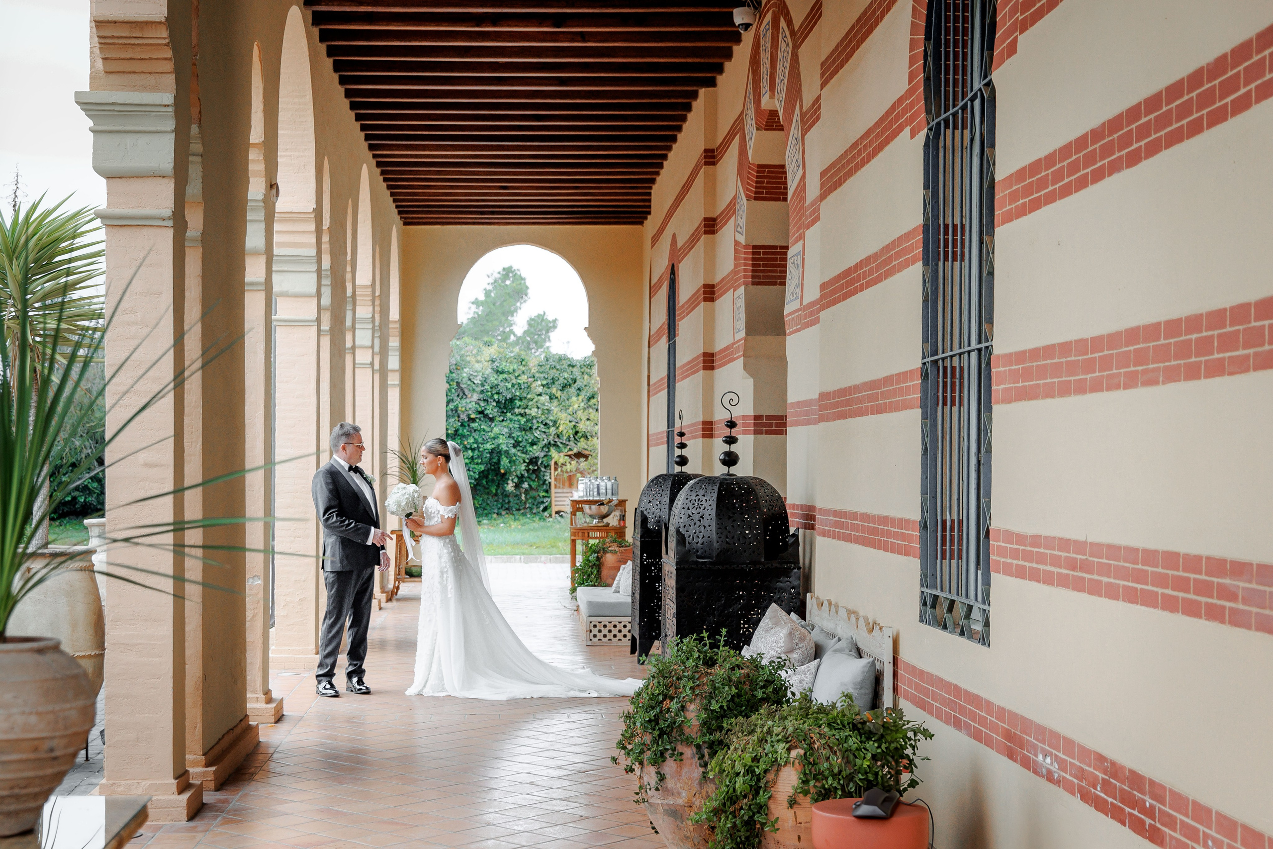 Emotional moment between bride and father before the ceremony, showcasing love and support in a picturesque Barcelona setting.