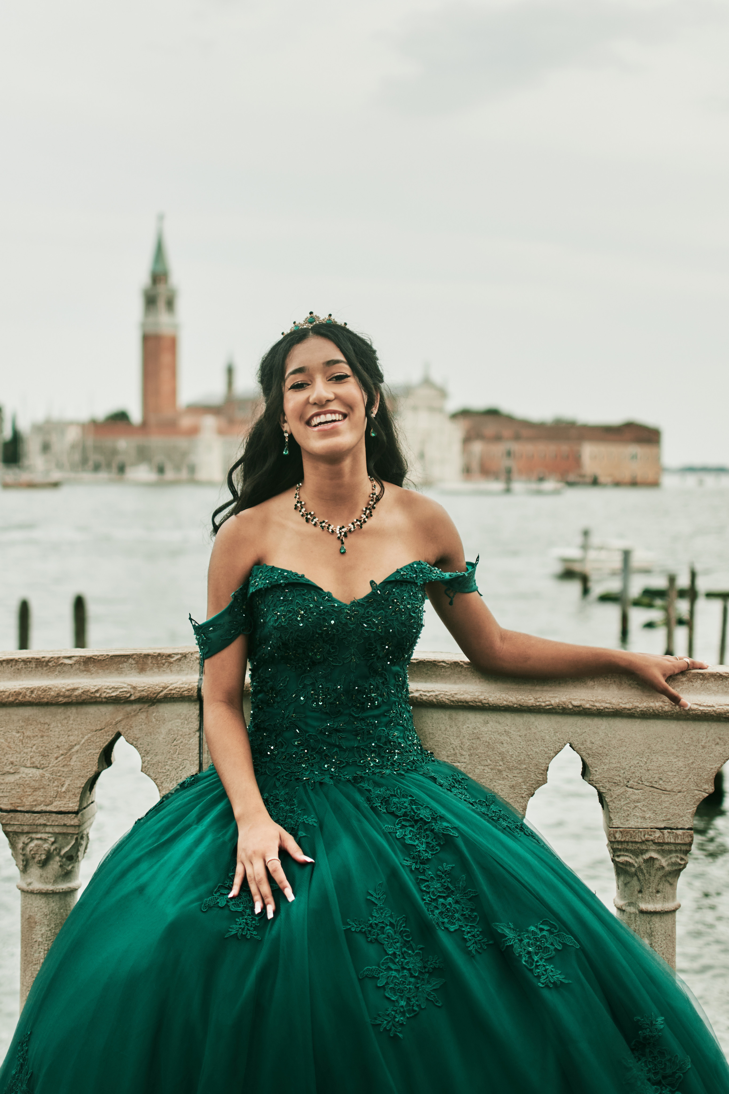 Enchanting quinceanera moment captured in the heart of Venice at St. Mark's Square. Graceful girl in a vibrant green dress capturing hearts.