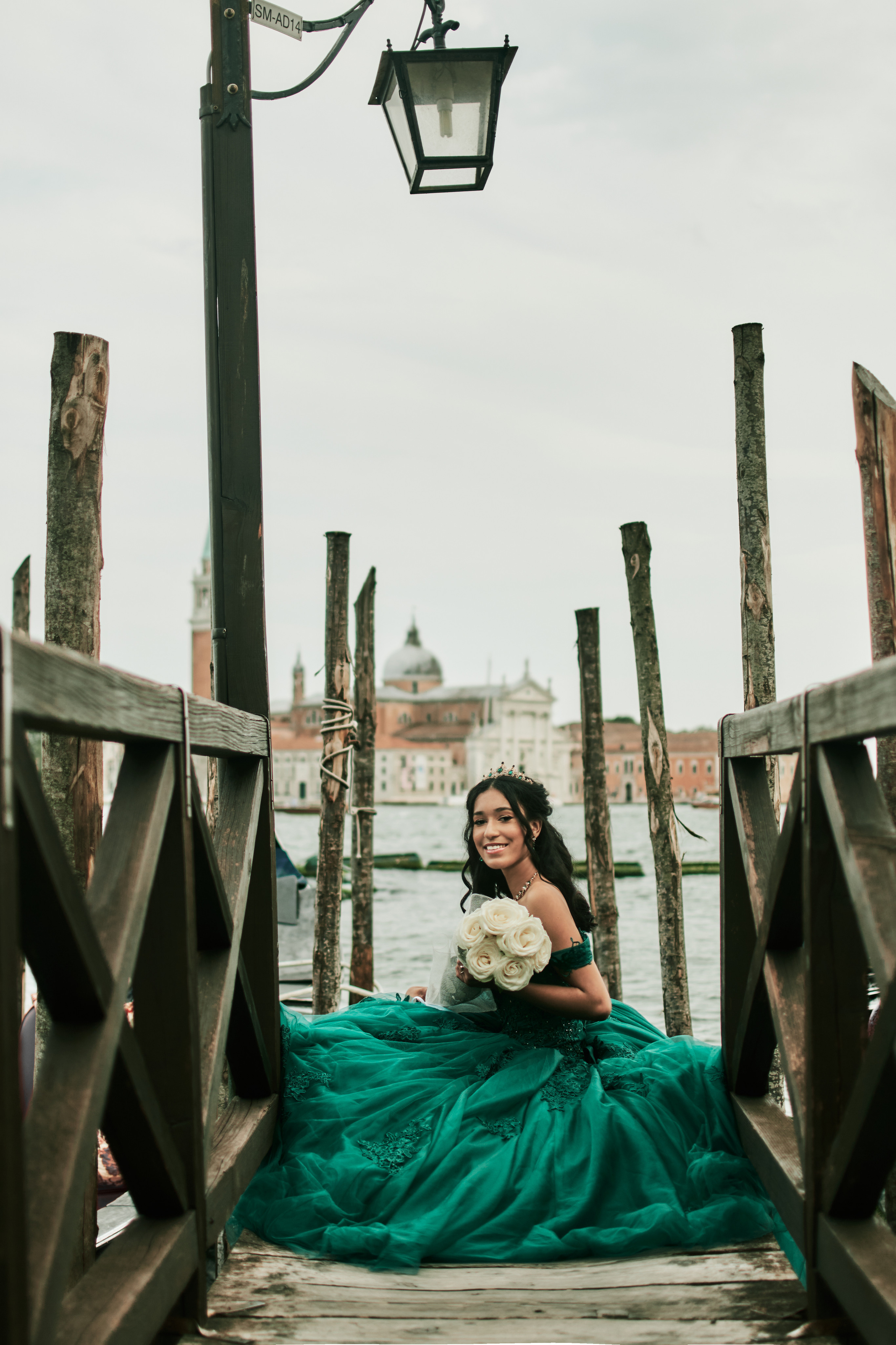 Quinceañera in the splendor of St. Mark's Square, Venice – a magical photoshoot. Elegantly dressed girl shines in a lovely green attire.