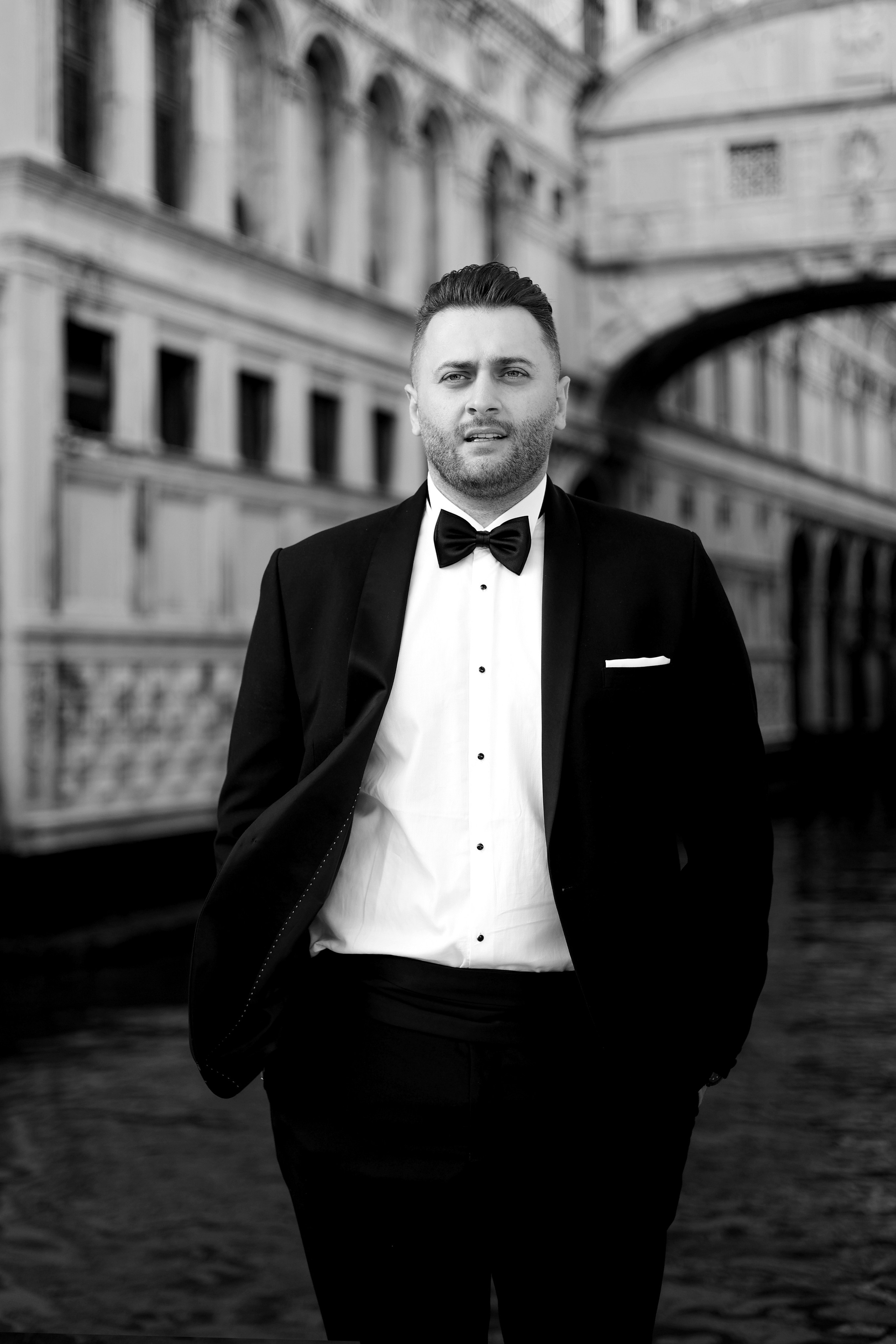 groom standing on a picturesque Venice square