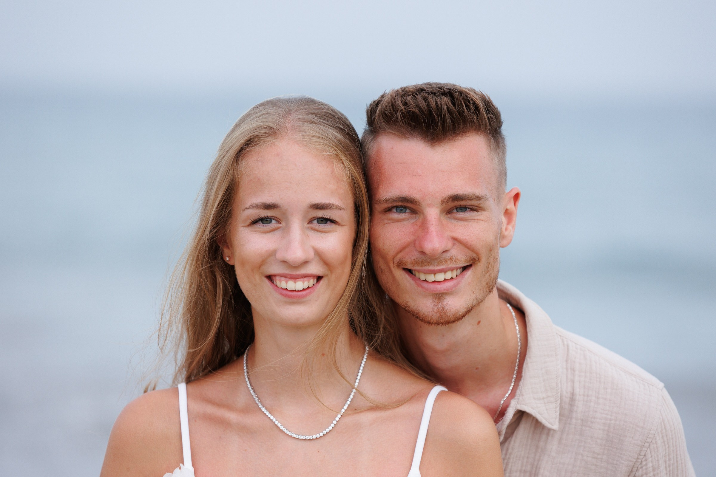 Couple laughing on Maspalomas beach vacation by Slavik Robtsenkov